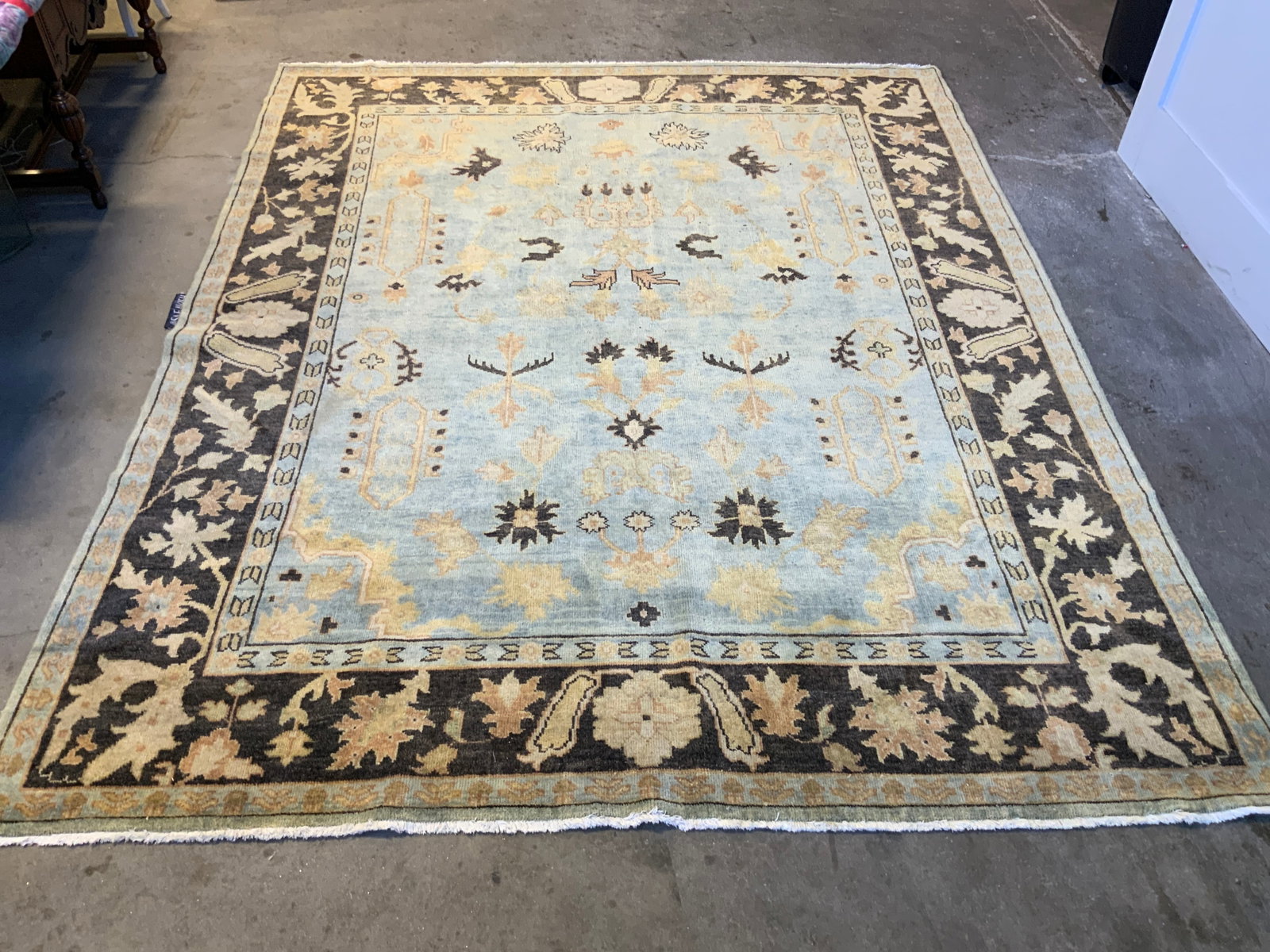 SAFAVIEH Vntg Handmade Wool Room Size Area Rug: Tag reads SAFAVIEH. Rug is handmade and wool. Piece appears to be vintage. Rug is room sized. Piece has multi toned floral motif detail. Edges have small cream toned fringes. Piece Measures approximat