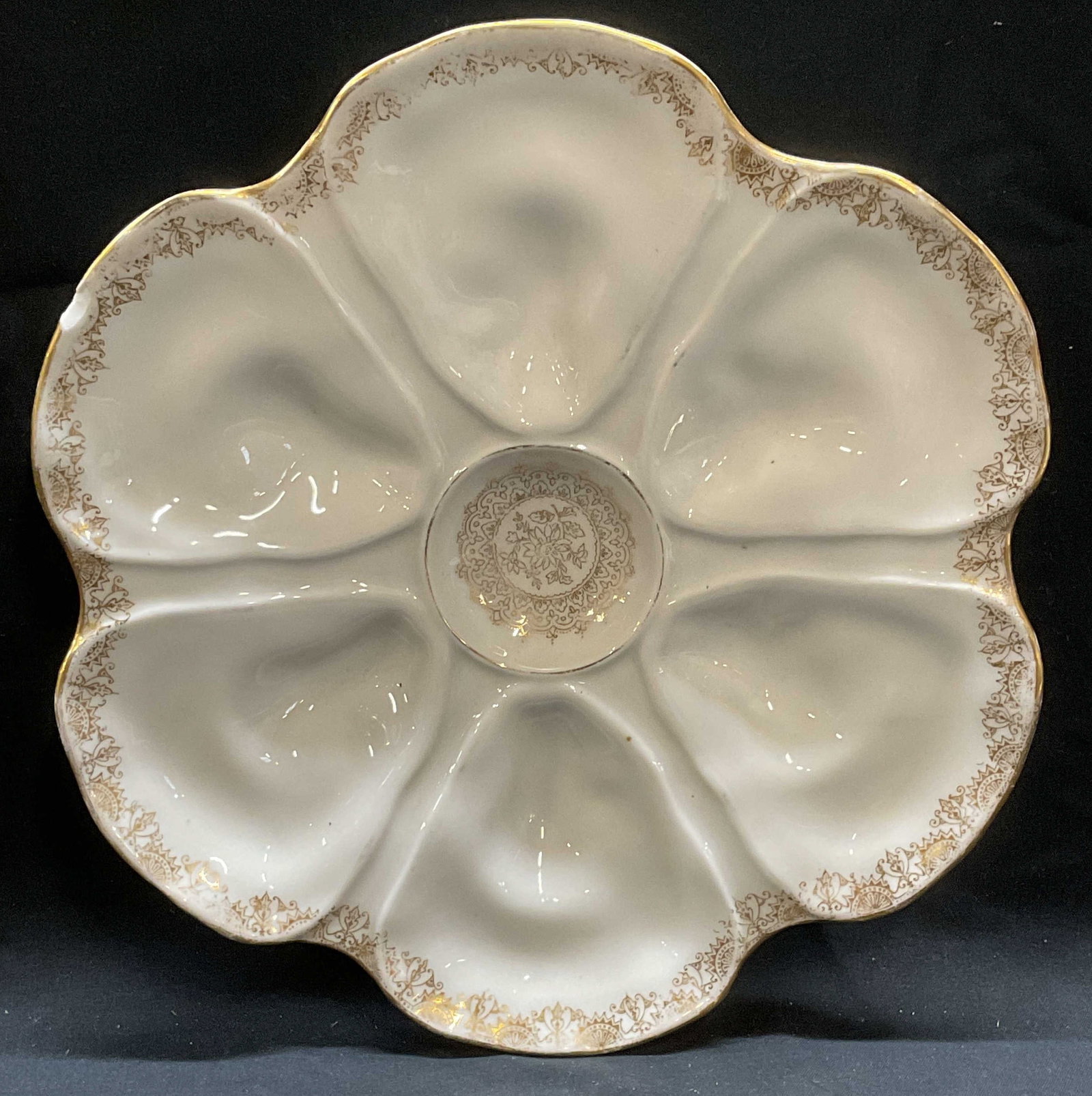Vtg LS & S Limoges Porcelain Oyster Plate, France: Vintage LS & S Limoges porcelain oyster plate, ornate gilt border. Wells for 6 oysters. Signed on underside. Made in France. Measures approx 9 inches wide. Wear including loss to paint and small chips