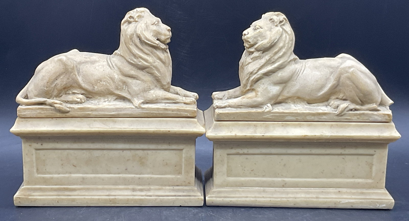 Pair AMR 1965 Vintage Lion Figural Bookends: Pair Vintage Lion Figural Bookends. Crafted from resinous material. Fabric to the undersides. Measures approx. 7H x 6.5W in. Reverse marked AMR 1965. Some surface wear consistent with age, use, and ex