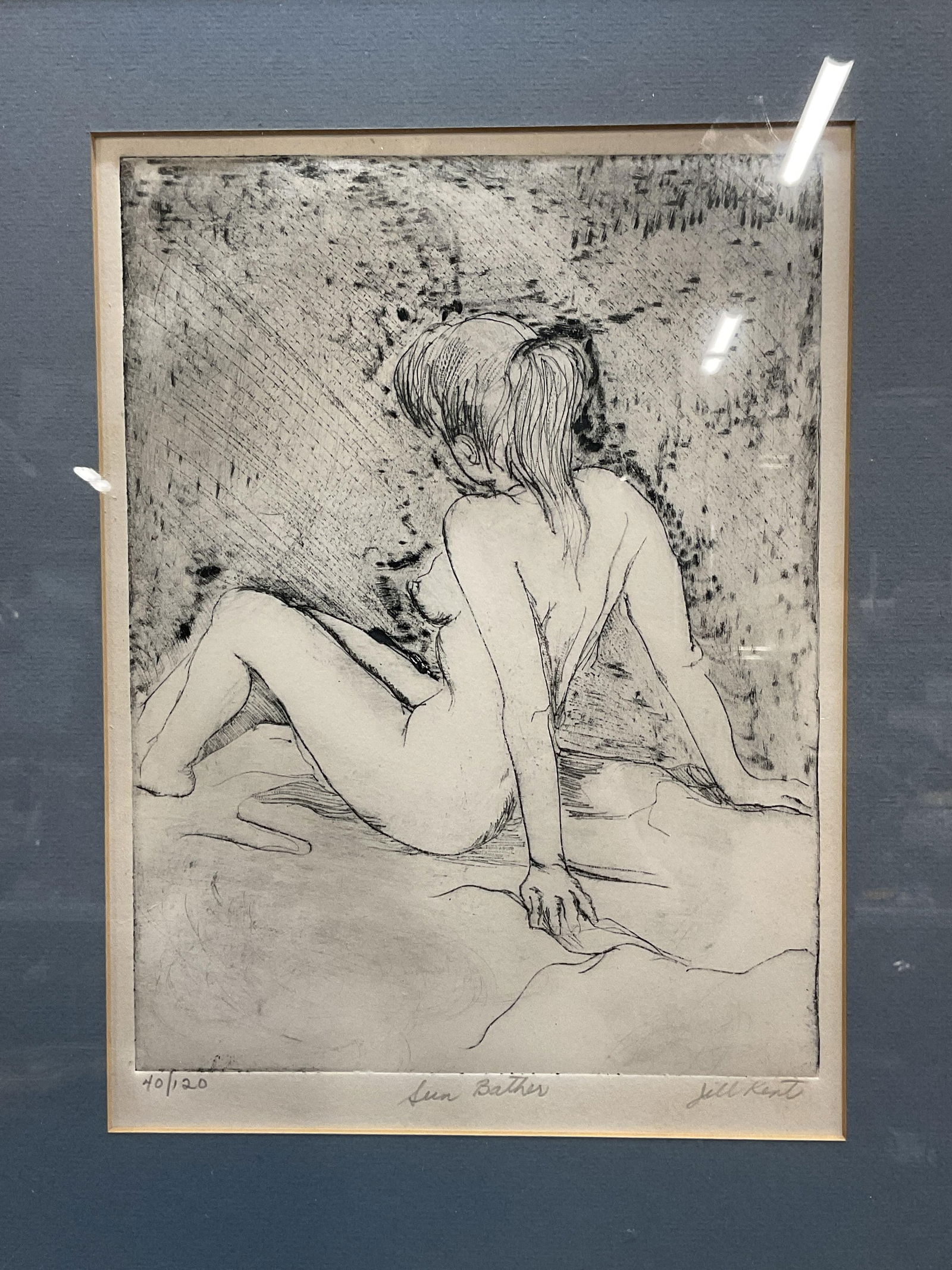 Signed Jill Kent Sun Bather Nude Woman Etching: Signed and framed etching by Jill Kent. Signed on lower right. Titled Sun Bather. Numbered edition 40/120. Posterior profile view of a nude woman. Framed in black wood framed under mat. Measures appro