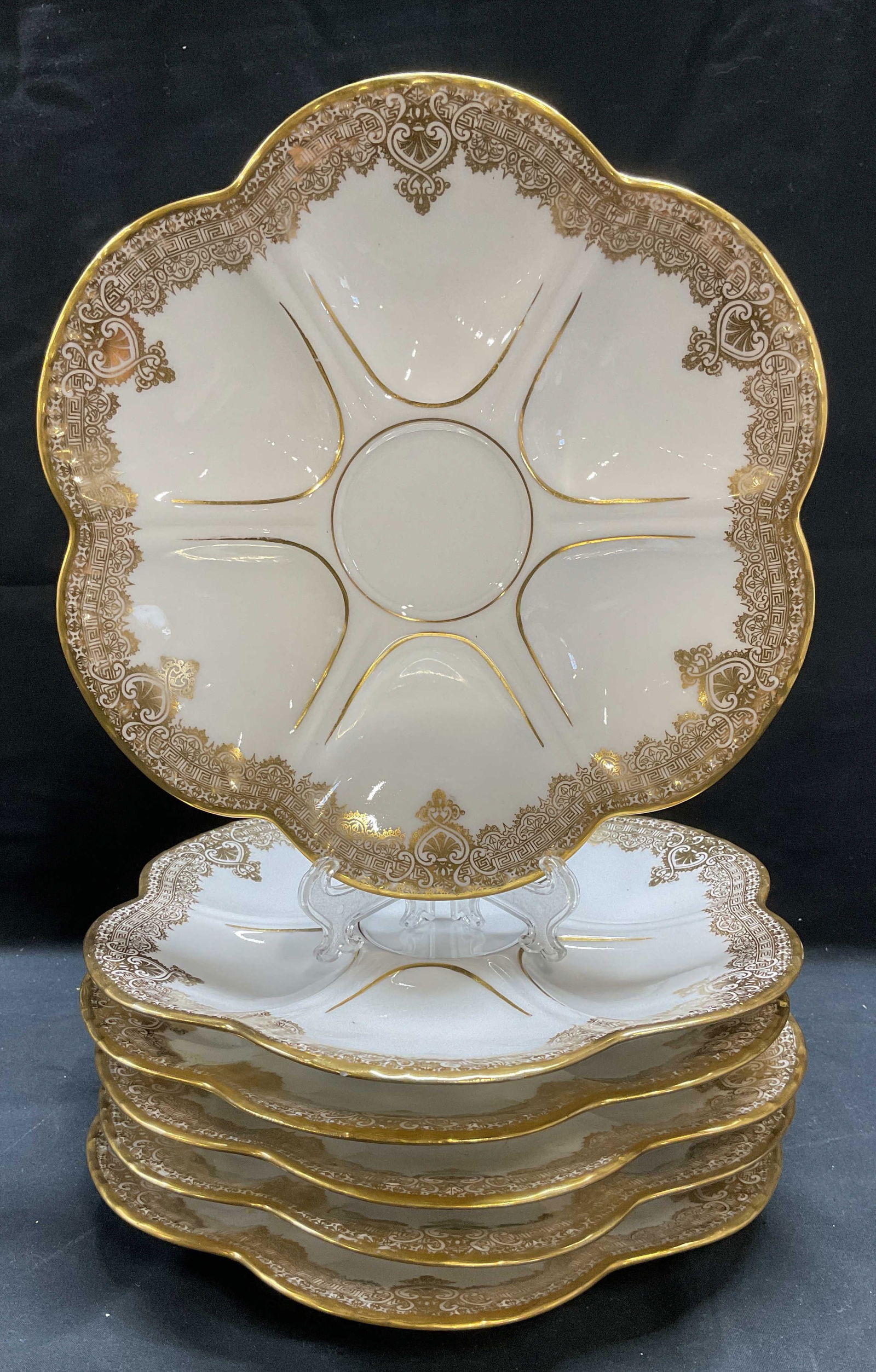 6 Limoges BERNARDAUD D & C France Oyster Plates: Set of 6 vintage Limoges porcelain oyster plates. Signed on undersides, L. BERNARDAUD & Co, D & C France, Higgins & Seiter New York. Made in France. White with ornate gilt dyed. Wells for 6 oysters. A