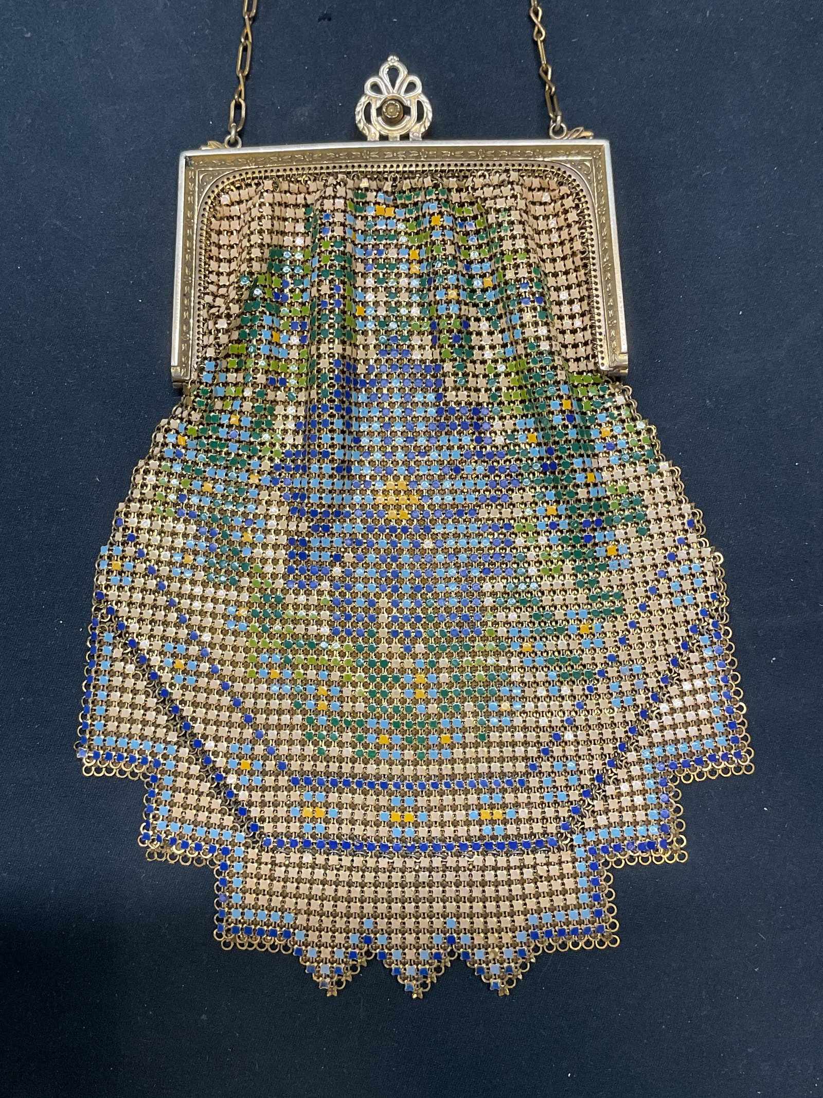 Vtg Whiting & Davis Enameled Floral Mesh Handbag: Vintage Whiting and David gold tone mesh handbag. Enameled metal, with floral motif in yellow, blue, and green. Embossed scroll frame. Signed on interior frame. Measures approx 7 x 5.5 inches. Some sc