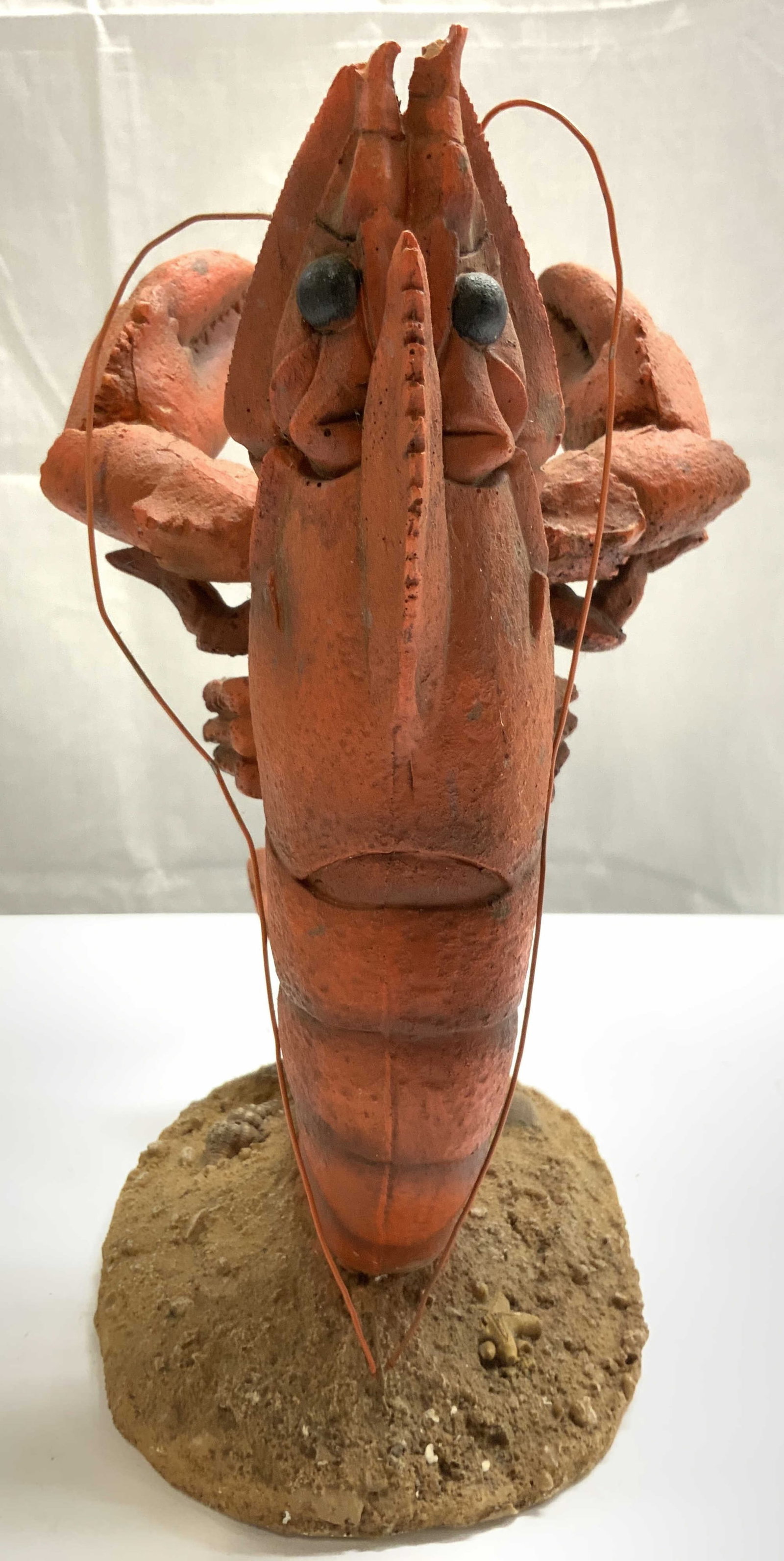Don Wasserman Nautical Lobster Wine Holder: Wine bottle holder appears to be DON WASSERMAN (no apparent markings). Piece is in the form of a lobster. Base of piece resembles sand. Piece appears to be composite. Wine holder measures approximatel