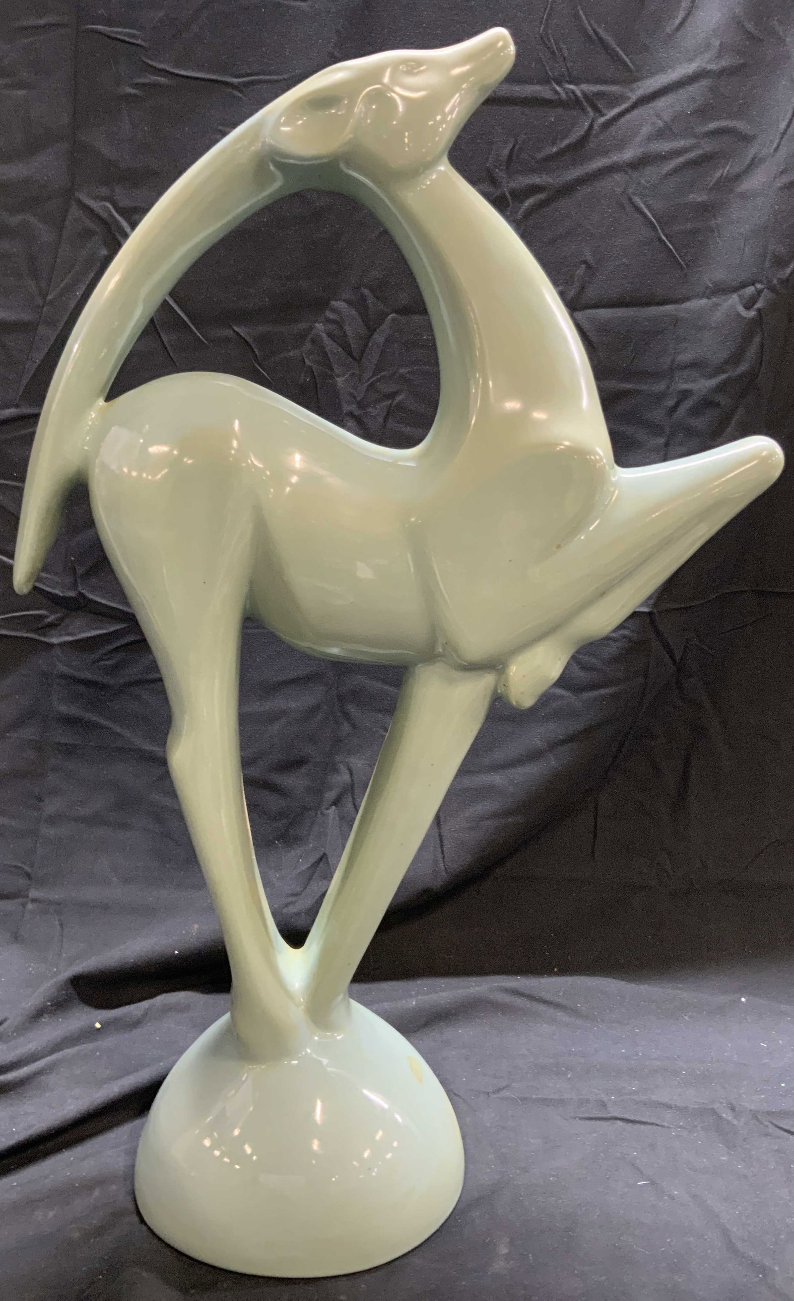 Royal Haeger Vtg Ceramic Gazelle Sculpture: Tag on underside reads HAEGER. Sculpture is ceramic. Piece is vintage. Sculpture depicts a gazelle with 1 front hoof raised. Piece is light aqua toned. Sculpture measures approximately 21.5 inches tal
