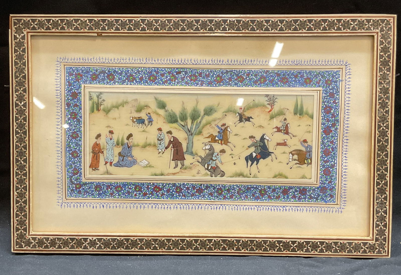 Framed Signed Persian Miniature Painting: Framed and signed Persian miniature painting. Signed at lower center. Appears to be on bone, possibly temper or watercolor. Scene depicting a polo game with men on horseback. Framed and matted in Khat