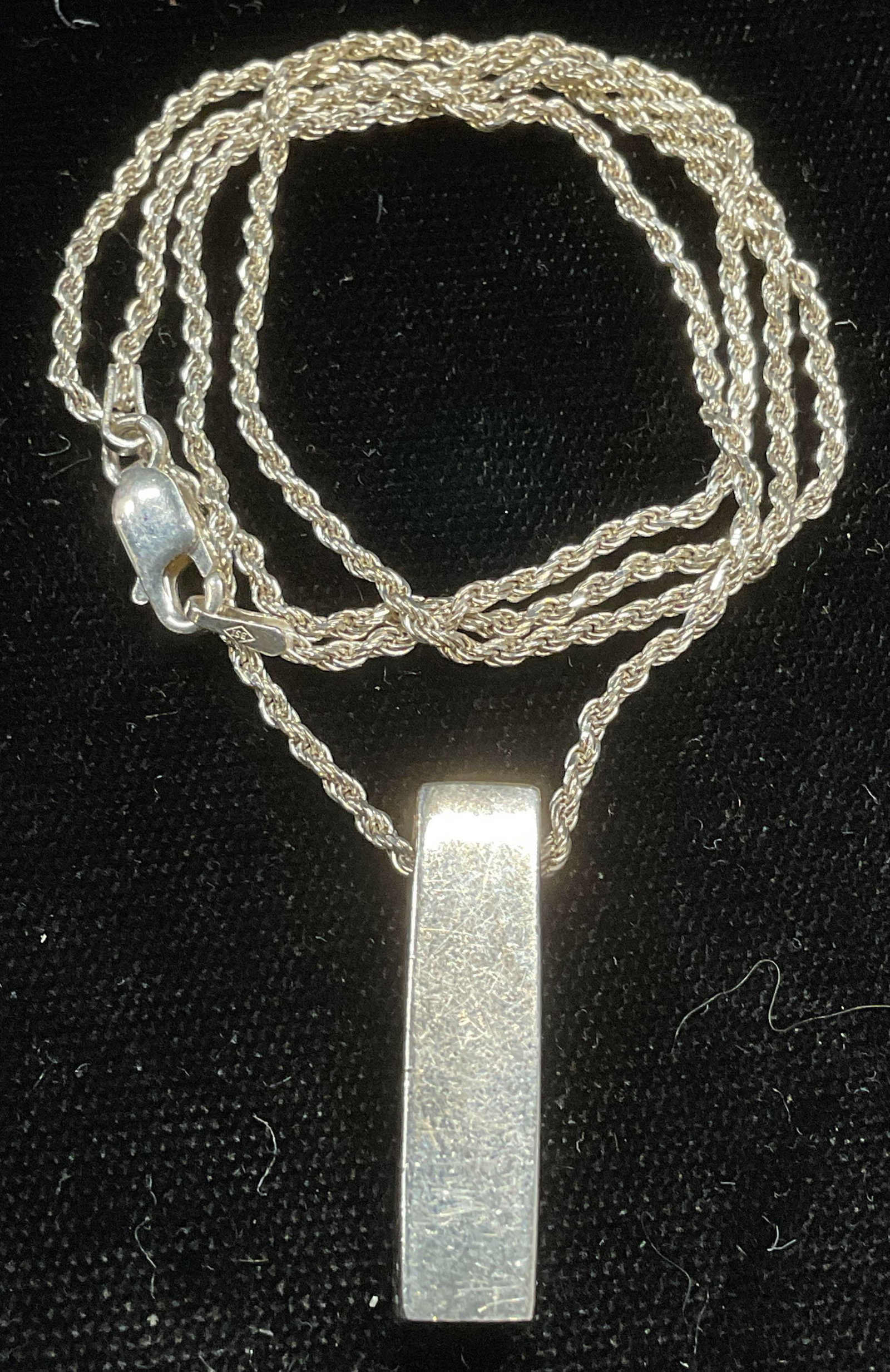 BSI Sterling Silver Pendant Necklace, Italy: BSI Sterling silver pendant necklace. Rectangle pendant. Signed on clasp. Marked 925 on pendant and clasp. Made in Italy. Drop length approx 9 inches. Total weight .28 ozt. Some scratching observed. J