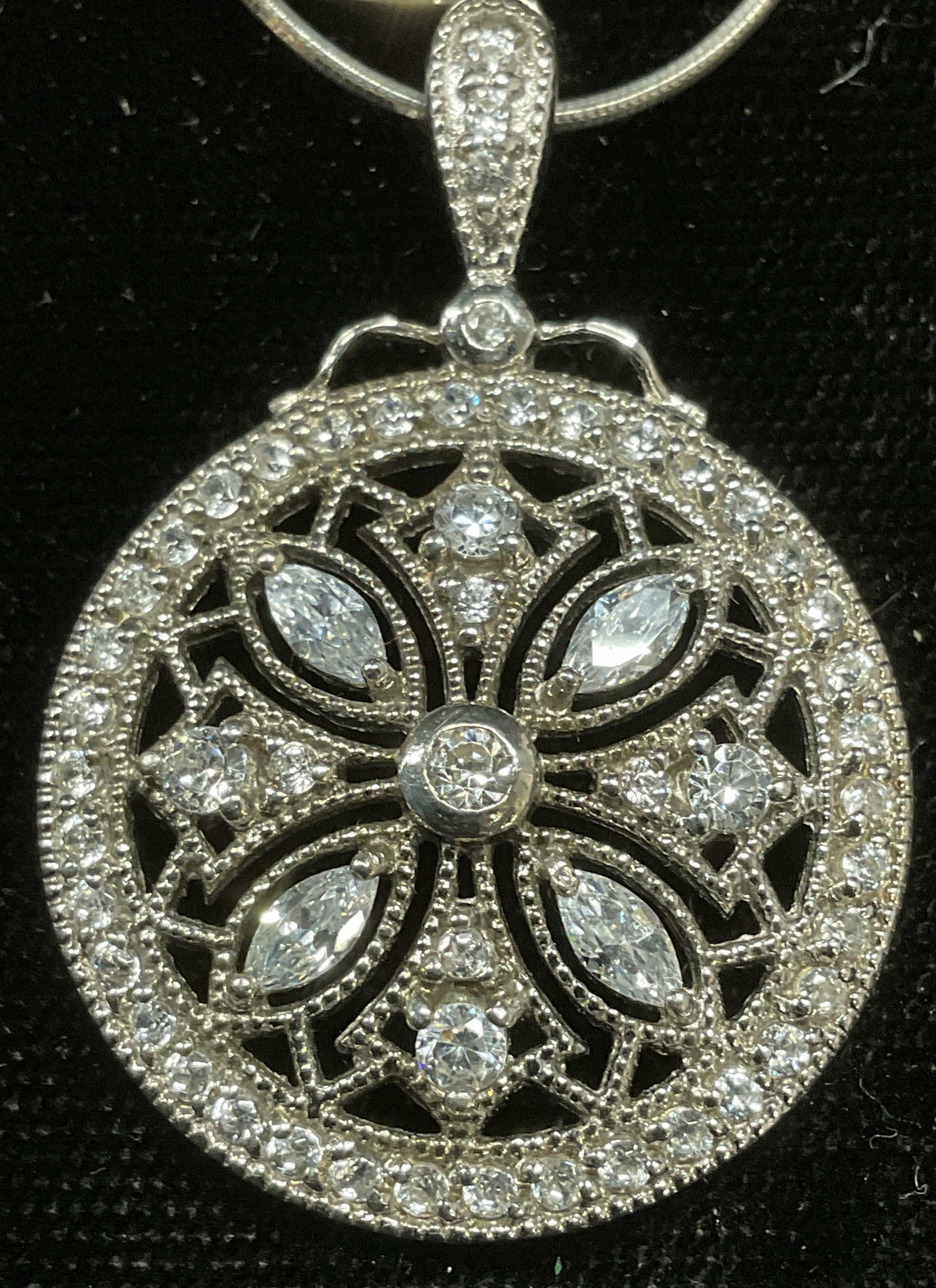 Sterling Silver Semiprecious Pendant Necklace ITAL: Sterling silver necklace with colorless semiprecious stone pendant. Decorative floral design. Made in Italy. Marked 925 on pendant and clasp. Drop length approx 8 inches pendant approx 1 inch wide. To