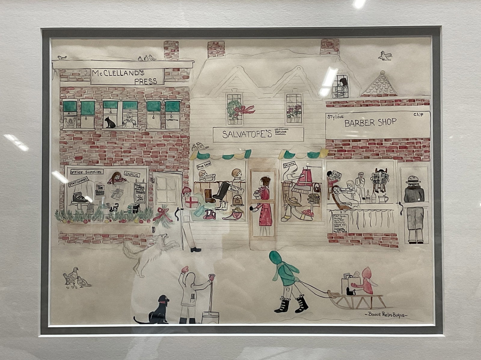 Sgn Bonnie Phelps Burns Winter Street Painting: Framed, matted and signed watercolor painting by Bonnie Phelps Burns. Signed at lower right. Winter street scene with storefronts, figures, and children with sled. Framed in wood frame. Not examined o