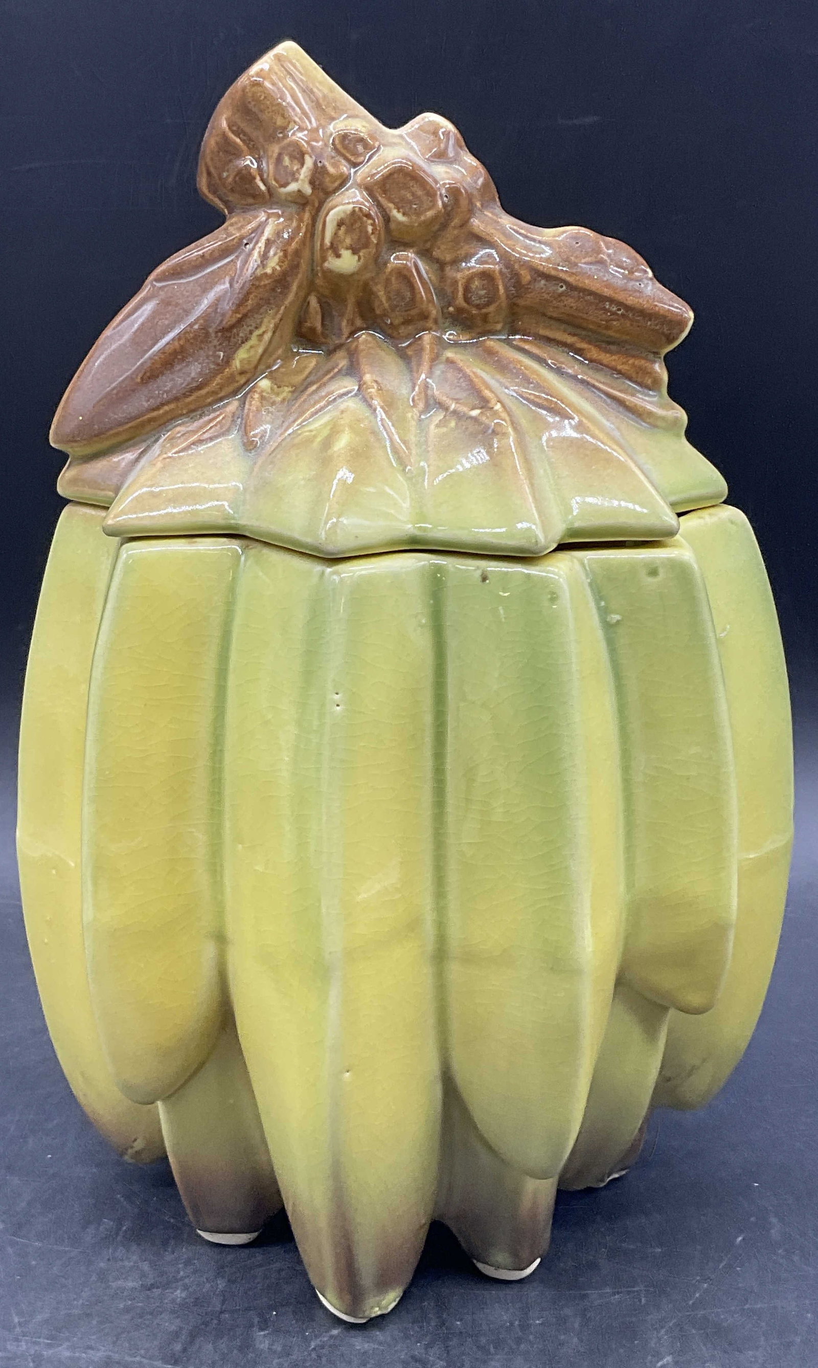 MCCOY Vintage Ceramic Banana Bunch Jar, Lidded: MCCOY Vintage Ceramic Banana Bunch Jar. Lidded. Measures approx. 10.5H x 6W in. Underside signed MCCOY. Pitting, crazing, discoloration, and surface wear present. Imperfections present. home decor, ho