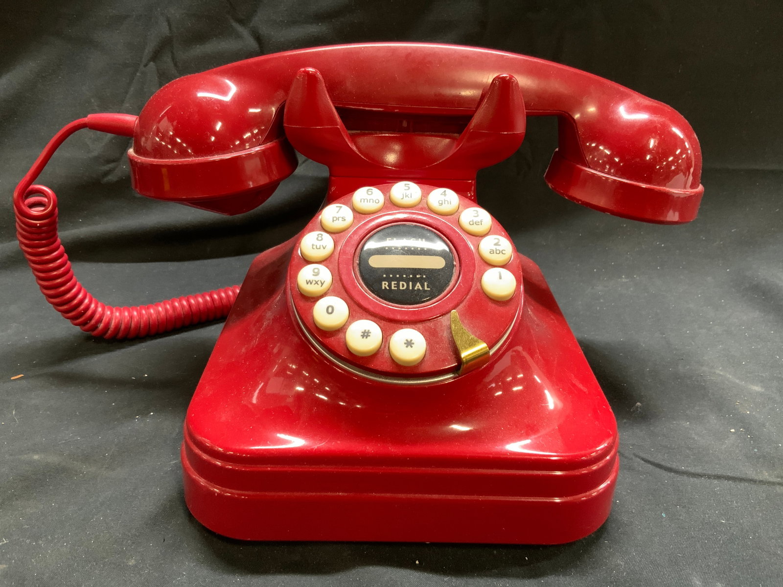 Vtg GRAND PHONE Rotary Style Phone Red: Tag on Underside reads GRAND PHONE. Phone is vintage, piece is red toned. Phone has rotary style. Piece has white toned buttons with black text and flash redial button in center of dialing pad. Teleph