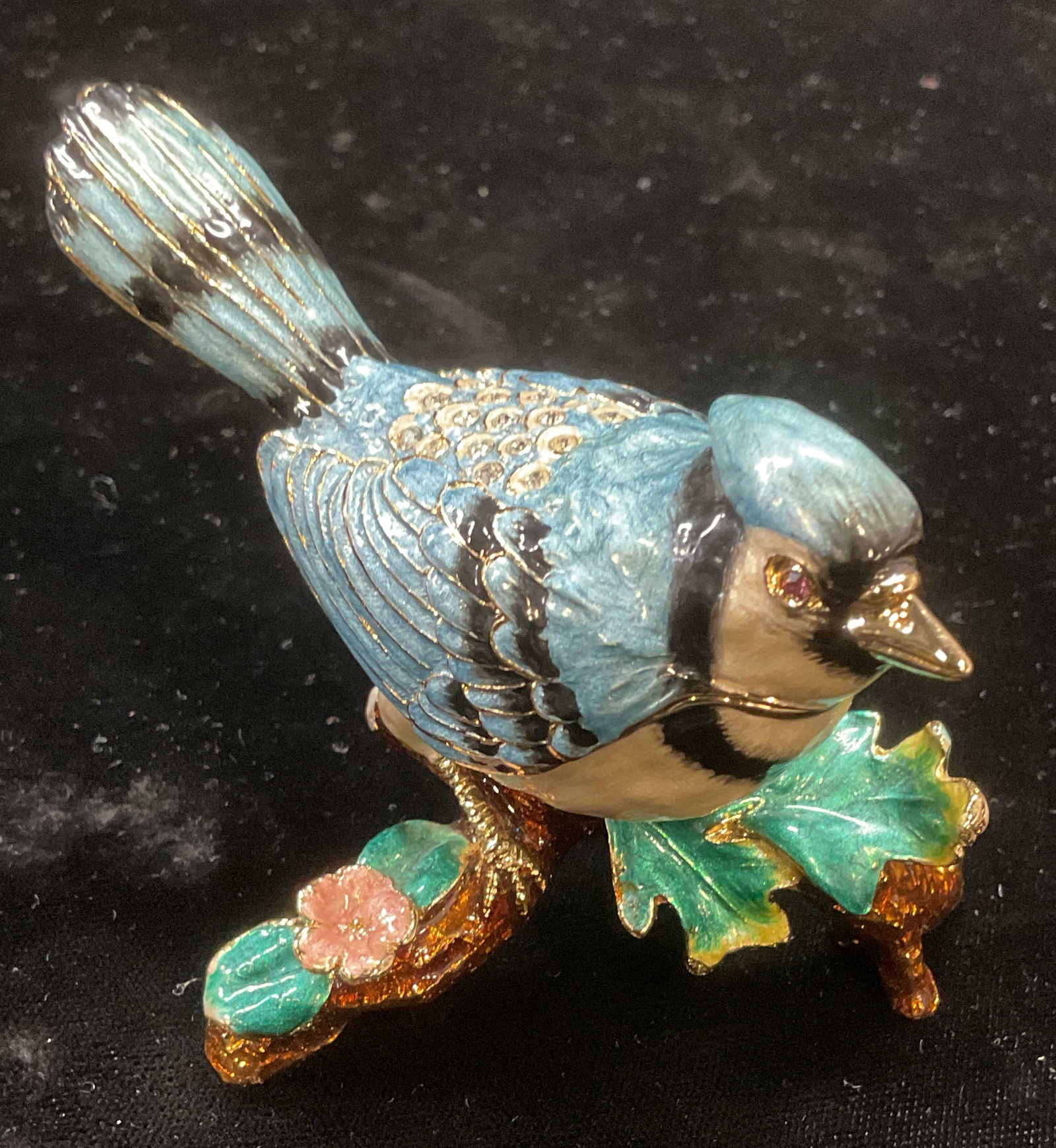 Signed Enameled Crystal Blue Jay Trinket Box: Signed blue jay bird on branch motif trinket box. Enamel over metal with crystal decoration. Signed on underside. Includes box with fitted interior. Piece has weight. Measures approx 3.75 x 2.75 x 2.7