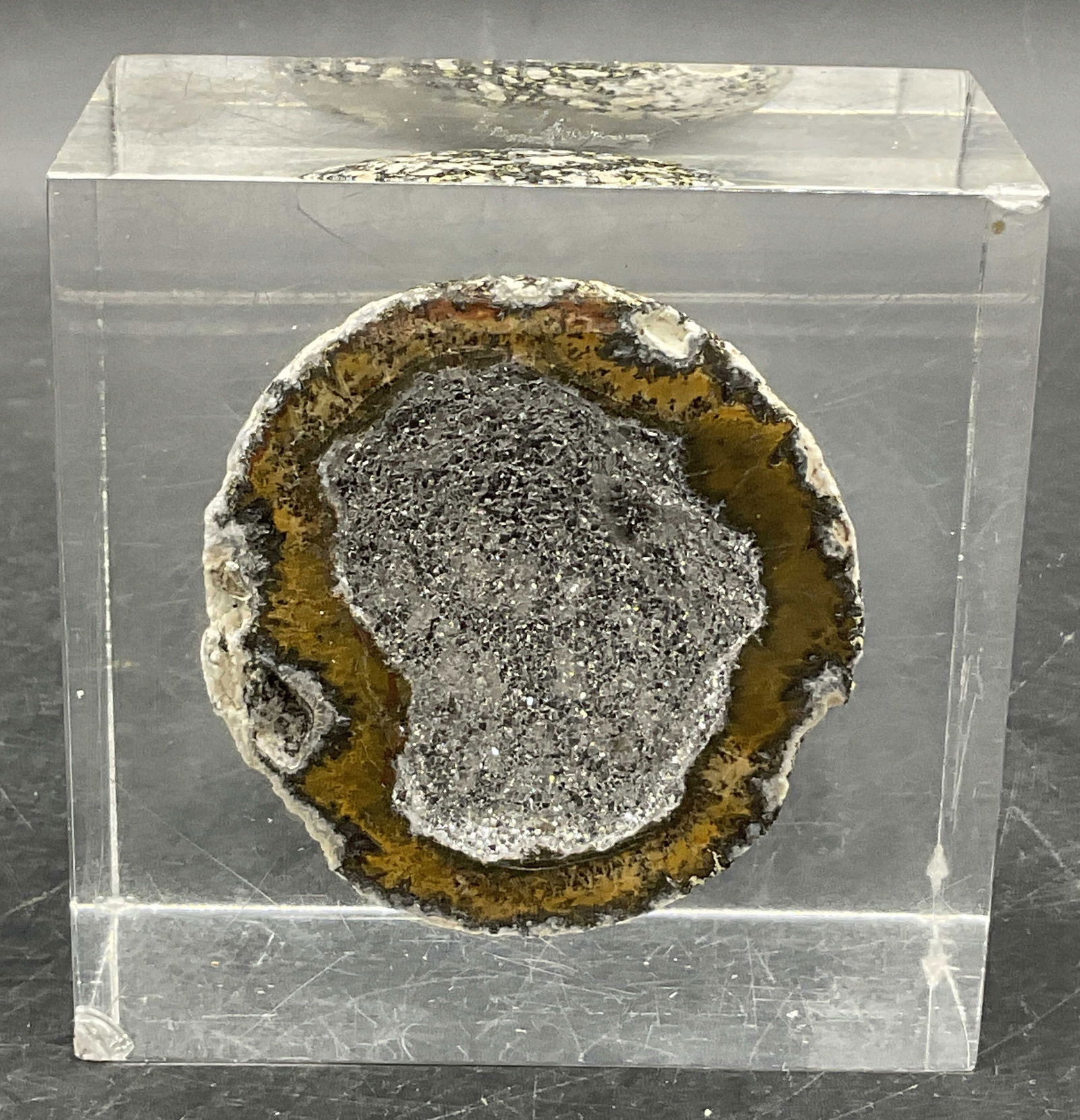 Lucite Encased Geode Specimen: Lucite Encased Geode Specimen. Shimmery interior to the geode. Measures approx. 4H x 4W in. Chipping and surface wear present. home decor, home accents, homewares, housewares, home accessories, collec
