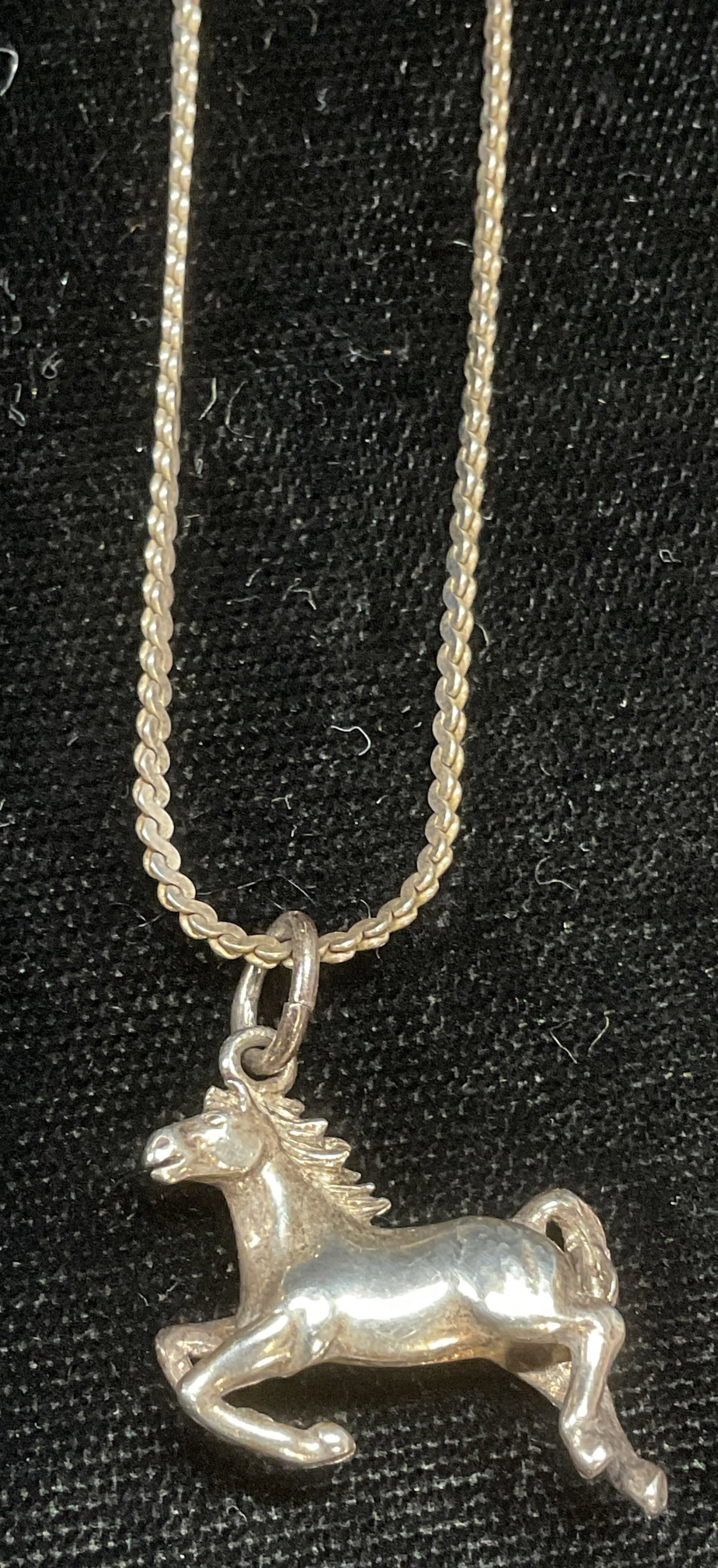 Vintage Sterling Silver Horse Pendant Necklace: Vintage sterling silver chain necklace with sterling silver horse pendant. Signed on pendant and marked sterling. Marked sterling, made in Italy on chain. Drop length approx 7 inches. Pendant approx. 