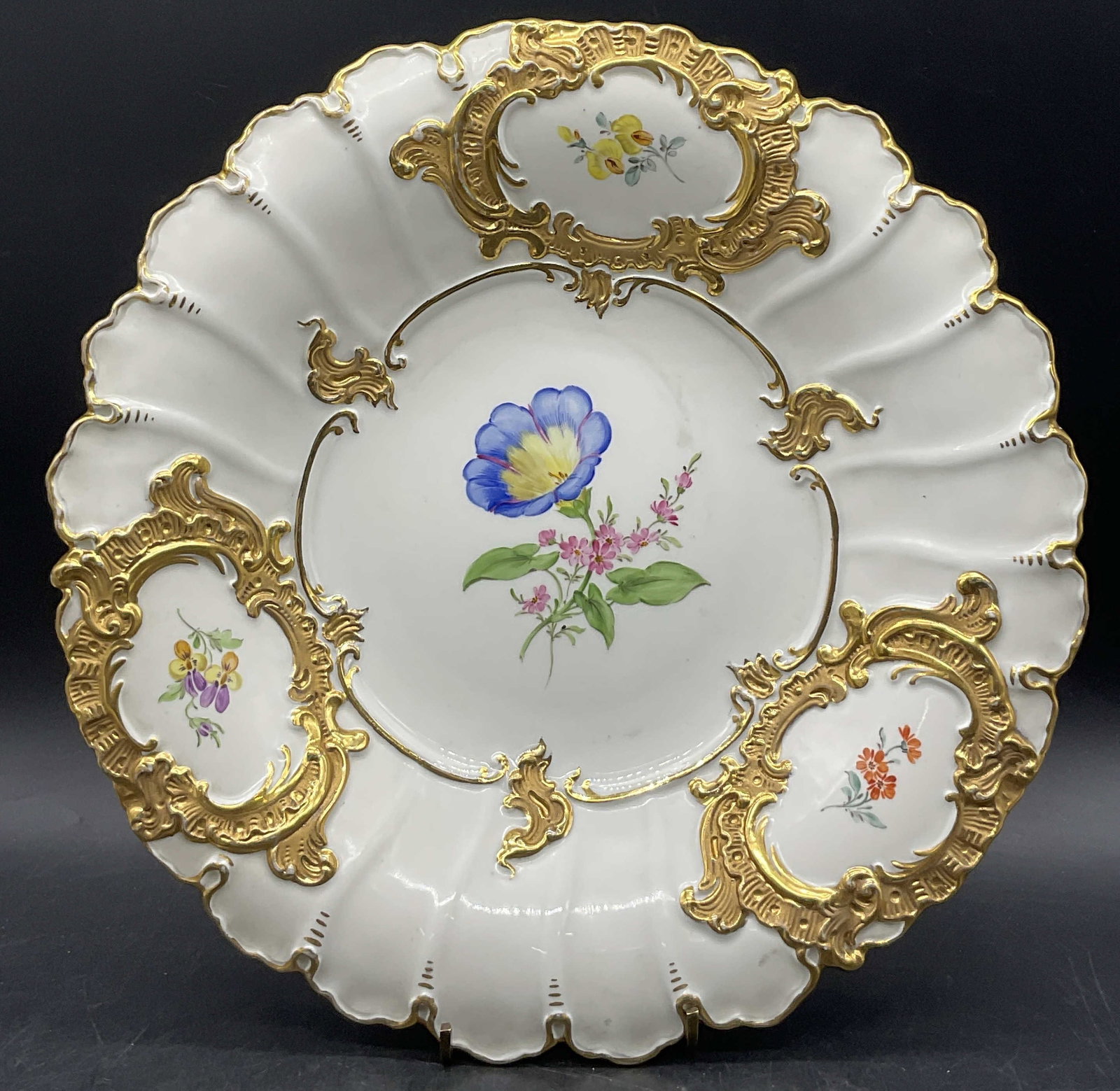 Meissen Trademarked Porcelain Floral Motif Plate: Meissen Trademarked Porcelain Floral Motif Serving Plate. Underside is trademarked with crossed swords, appears to be Meissen. Numbers to the underside as well. Measures approx. 2H x 12W in. Thick wal