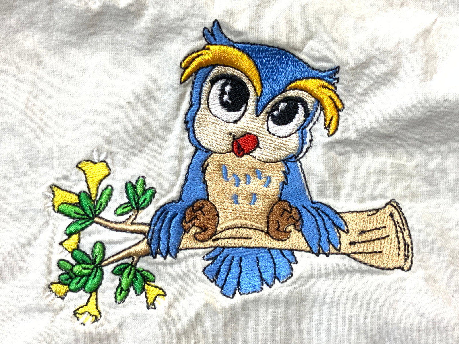 Vintage Embroidery Of Bird On Cloth: Embroidery is vintage. Home decor, tapestry, tablecloth, table linens, Piece embroidery of cartoon bird figure perched on a branch. Cloth is cream white toned. Piece measures approximately 31 inches t
