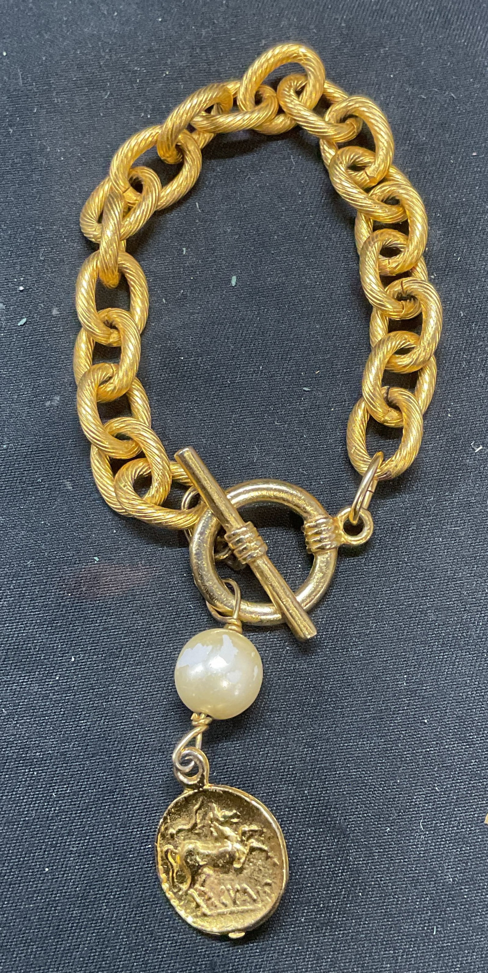 Vintage Gold Tone Faux Pearl & Coin Bracelet: Vintage gold tone chain bracelet with faux pearl and faux Ancient Greek coin motif pendants. Measures approx. 7 inches long. Some surface wear including scratching observed. Jewelry, estate jewelry, c