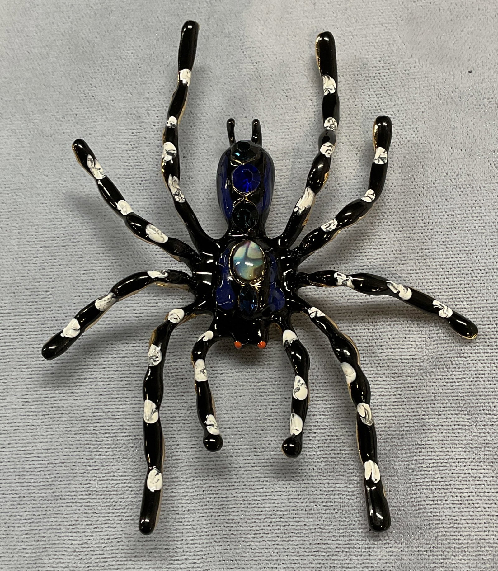 Black Enameled Crystal Spider Brooch, 3.5 In L: Black enamel and blue crystal decorated spider motif brooch. Hinge pin on underside. Measures approx 3.5 x 3 inches. Some wear including scratching. Jewelry, estate jewelry, costume jewelry, cocktail 
