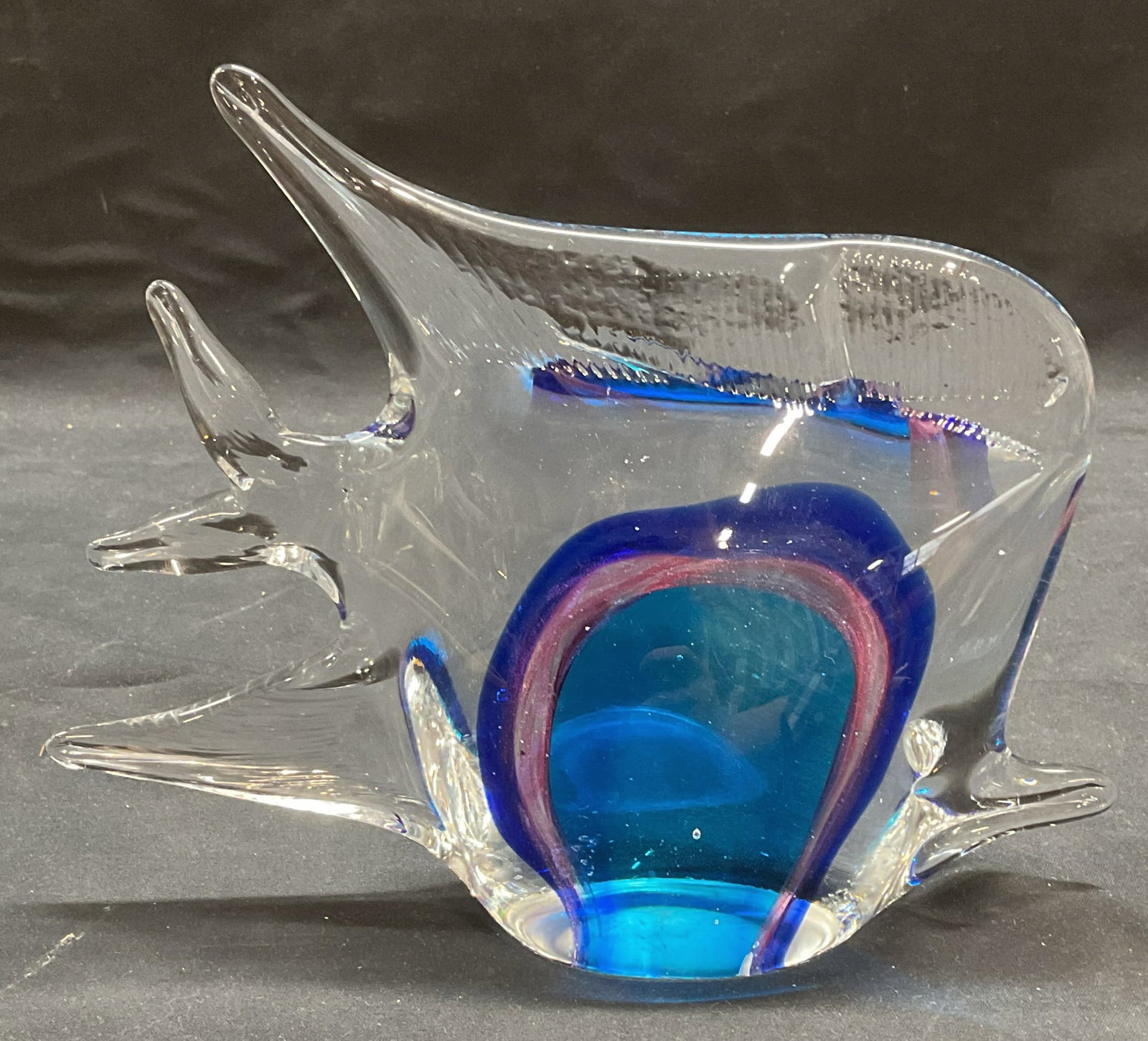 Hand Blown Blue Art Glass Angel Fish Figural: Hand blown art glass angel fish figural in clear, blue, and purple. Measures approx 8 x 2.25 x 6.25 inches. Some scratching and small chips observed. Art glass, art glass angel fish, art glass fish, a