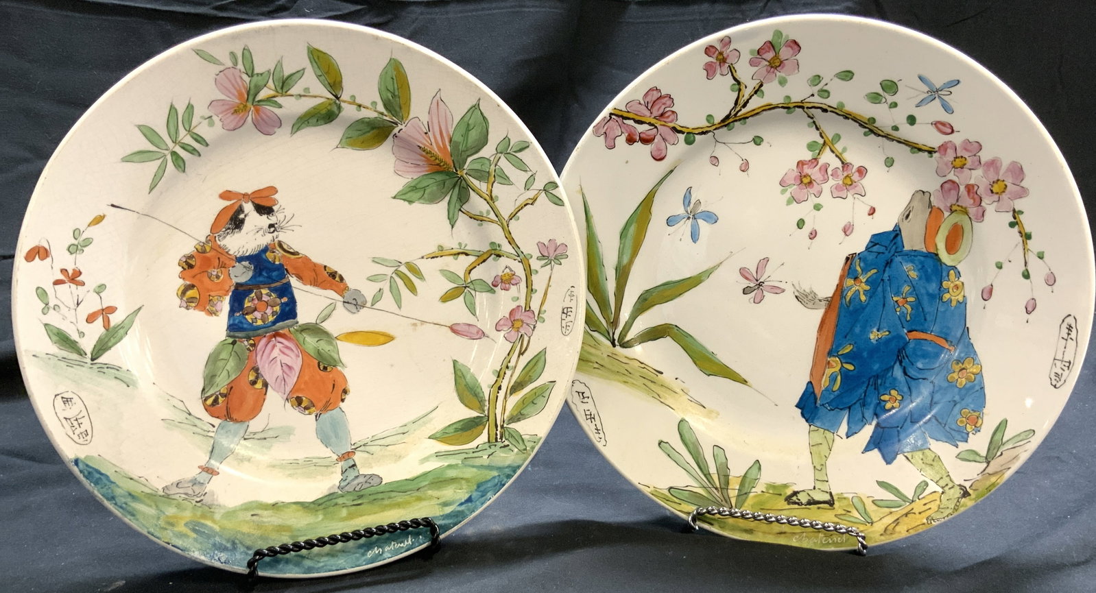DEPOSE CREIL ET MONTEREAU 2 H Painted Porc Plates: Undersides are marked DEPOSE CREIL ET MONTEREAU. Lot includes 2 plates. Each are hand painted. Each depicts animals wearing medieval clothing. Plates are each porcelain. Each measures approximately 9 