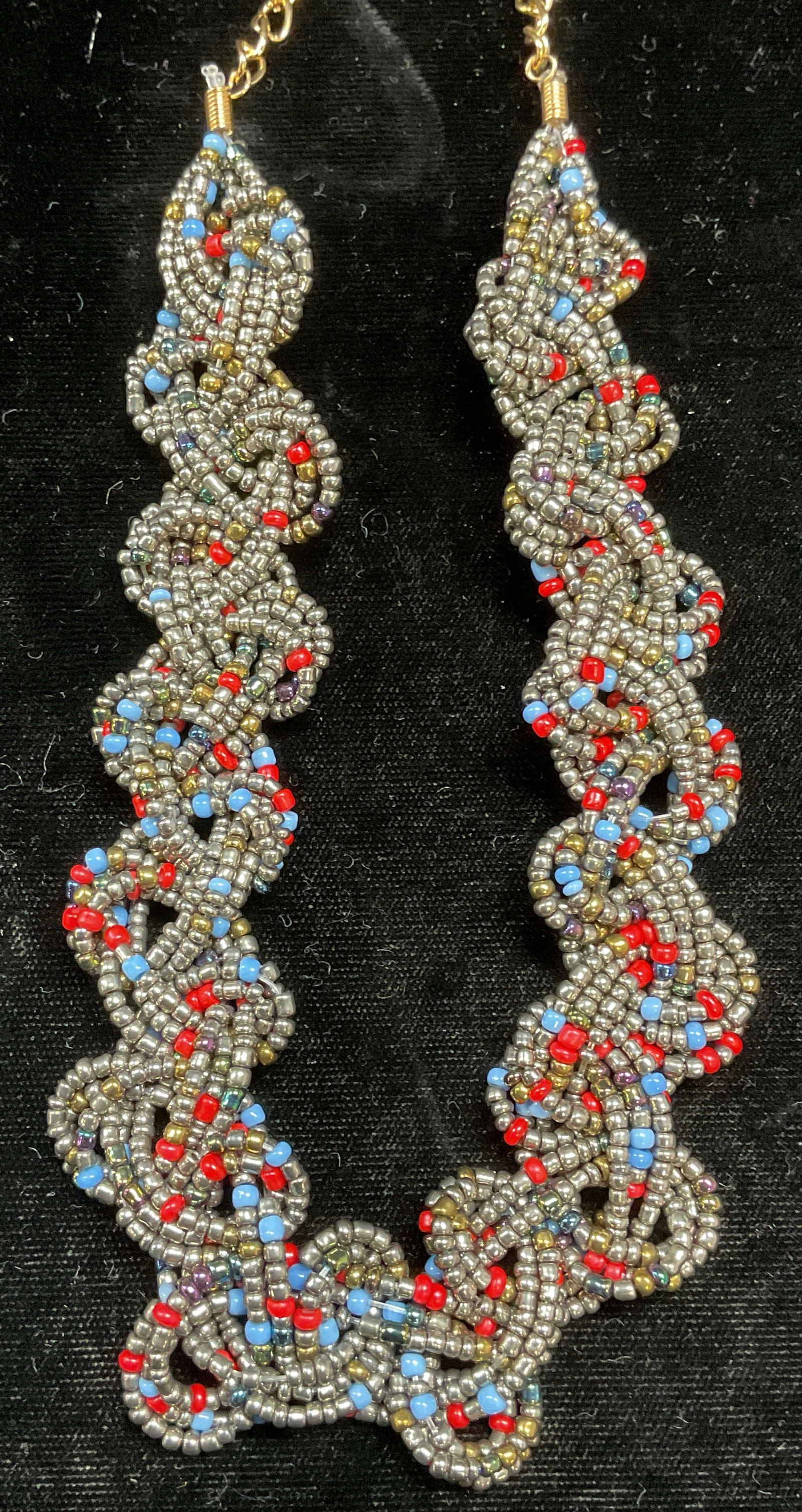 Silver Tone Red & Blue Beaded Woven Necklace: Silver tone, blue, and red seed beaded necklace with woven strands, gold tone chain. Drop length approx 10.5 inches. Some wear including scratching. Jewelry, estate jewelry, costume jewelry, cocktail