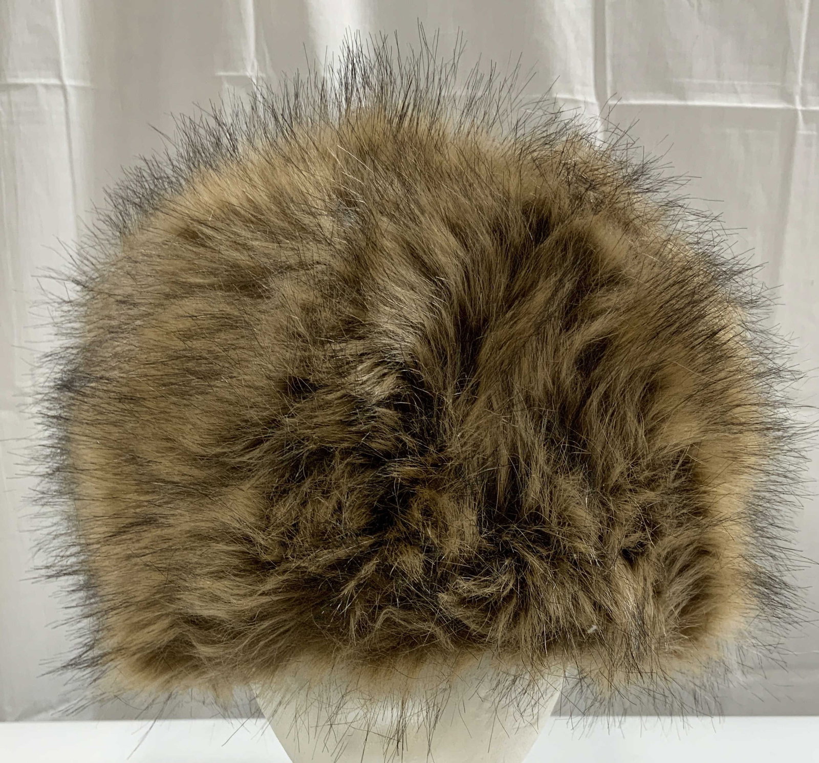 SOUL YOUNG Polyester Faux Fur Winter Hat: Tag reads SOUL YOUNG. Other tag reads POLYESTER. Hat is beige and brown toned. Interior is lined with black toned nylon. Hat measures approximately 9.5 inches wide & deep 7 inches tall. Hat, winter ha