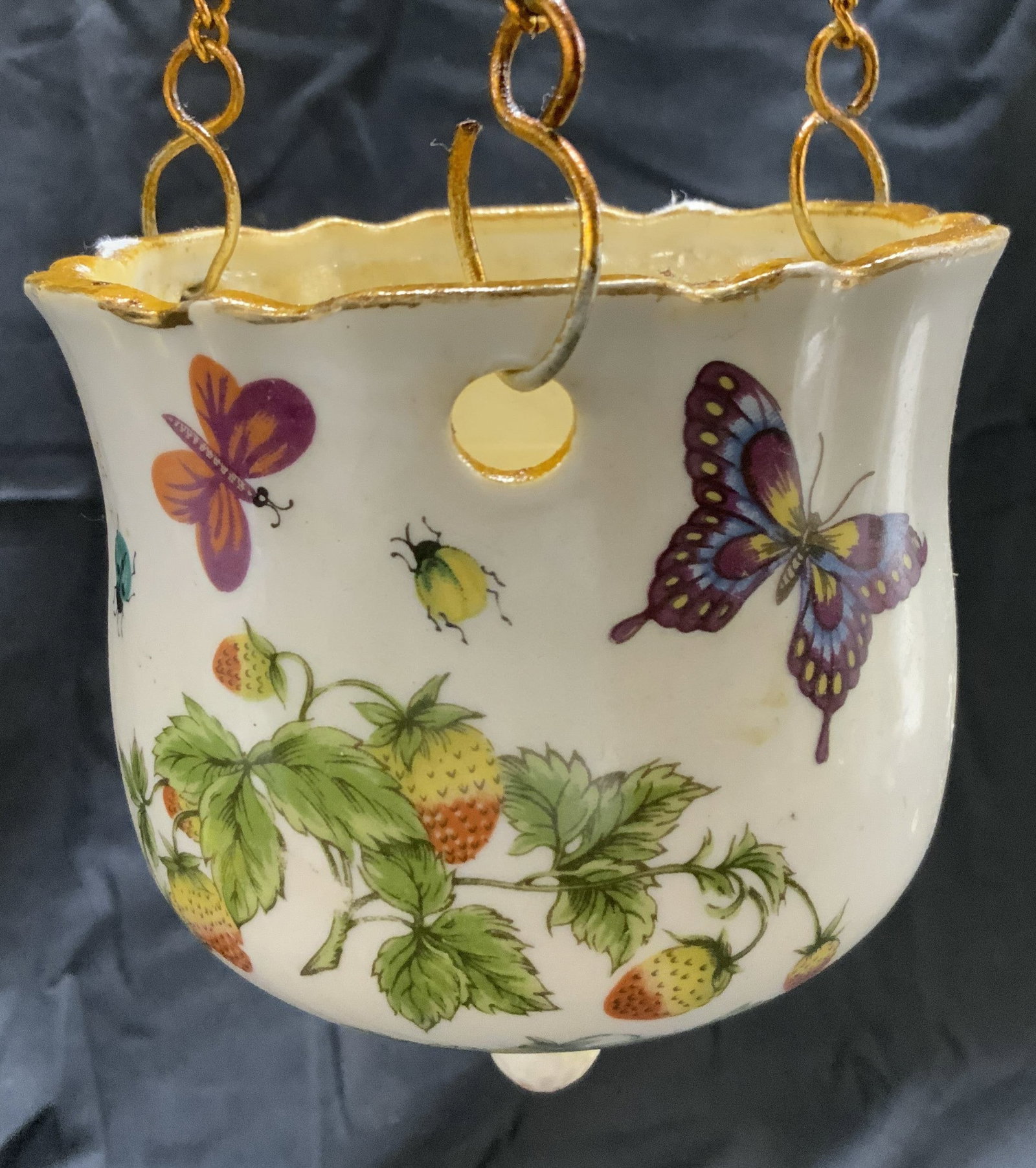 Vtg Floral Detailed Hanging Porc Planter Vessel: Vessel is vintage and porcelain. Piece has intricate multi toned floral, leaf, beetle, & butterfly detail. Planter is attached to gilt metal chain links and loop to hang piece. Vessel when hanging mea