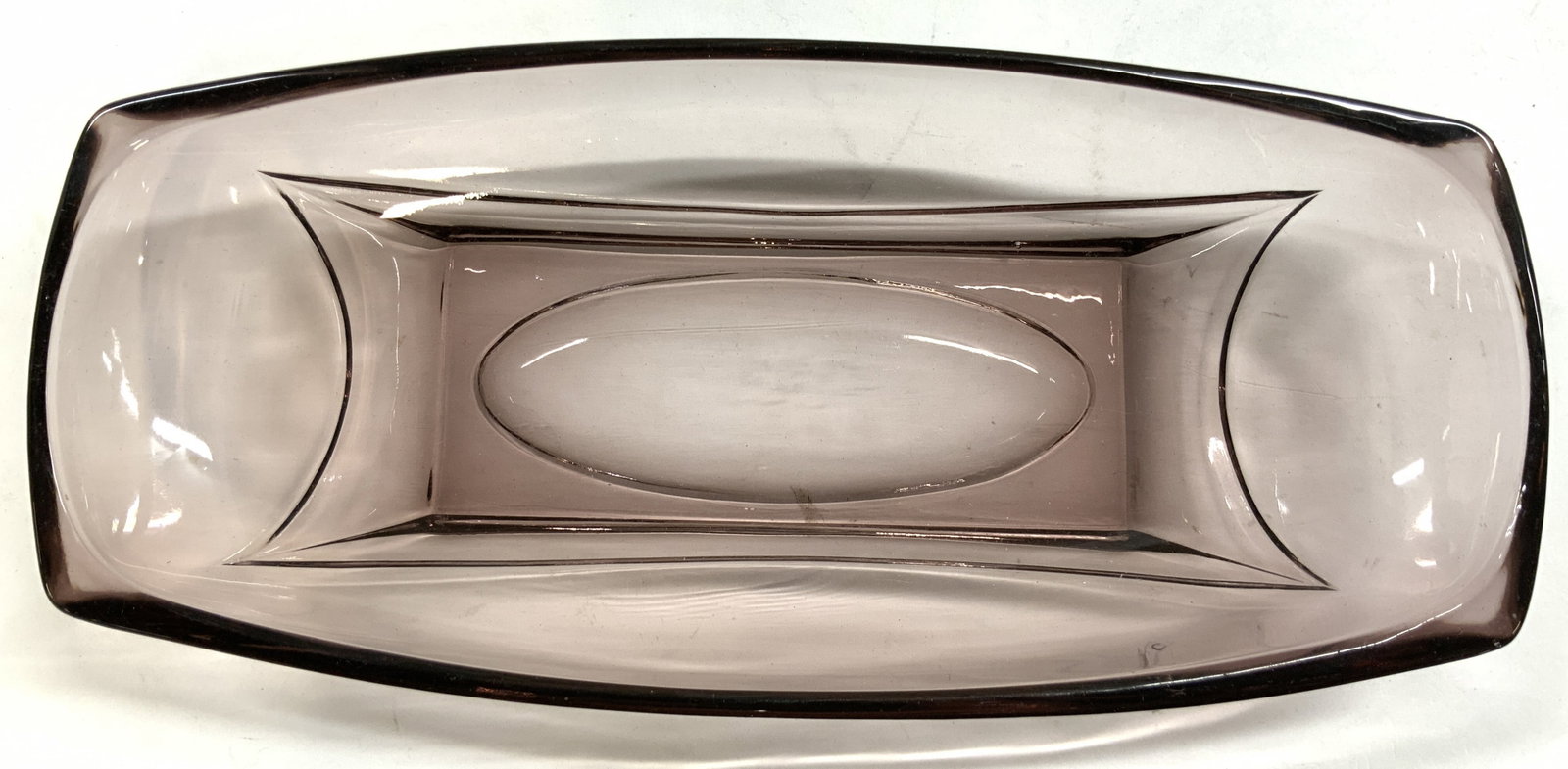 Moroccan Amethyst Hazel Art Gls Relish Dish: Relish dish is glass. Piece is amethyst toned. Moroccan art glass relish dish with slightly rounded sides. Piece measures approximately 9.5 inches long 4.5 inches deep 1.5 inches tall. Art glass, art 