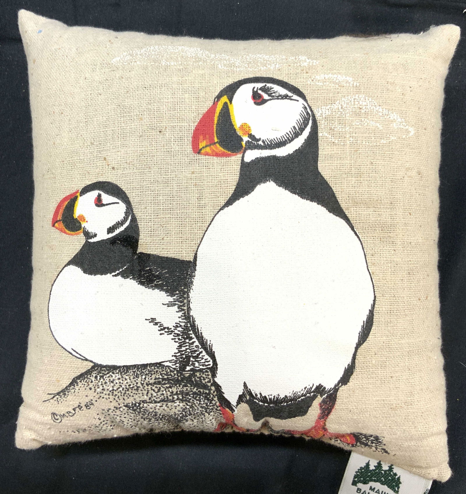 MAINE BALSAM FIR PROD Beanbag Puffin Pillow: Tag reads MAINE BALSAM FIR PRODUCTS. Beanbag pillow with depiction of puffins backside is black toned. One side of pillow appears to be canvas. Piece measures approximately 7 inches tall and wide 2.5