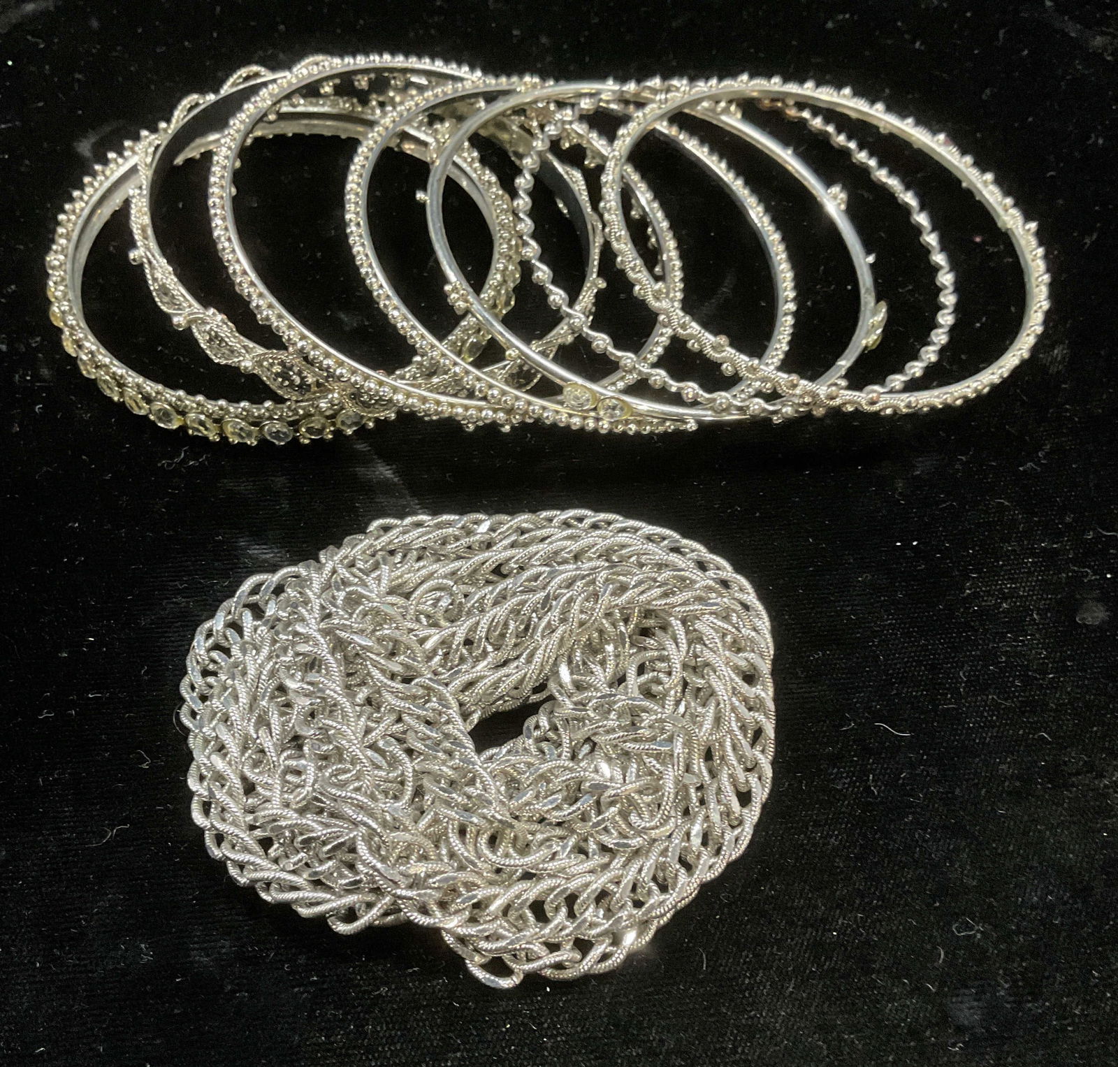 Group lot Silver Tone Bangles & Monet Necklace: Group lot of 7 silver tone bangles with crystal and raised decorations on bands and vintage Monet silver tone chain necklace. Signed on hang tag. Necklace drop approx 27 inches. Bangles approx 2.5 inc