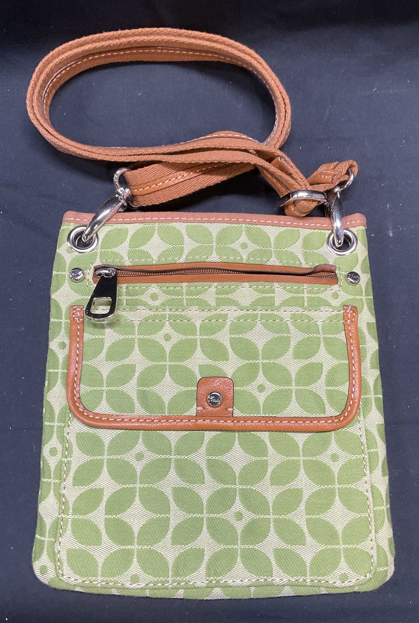 Fossil Green Canvas Floral Handbag: Fossil green canvas handbag with floral pattern and tan leather trim. Signed on interior. Measures approx 9.25 x 8 inches. Some wear to material consistent with exposure. Fossil handbag, designer hand