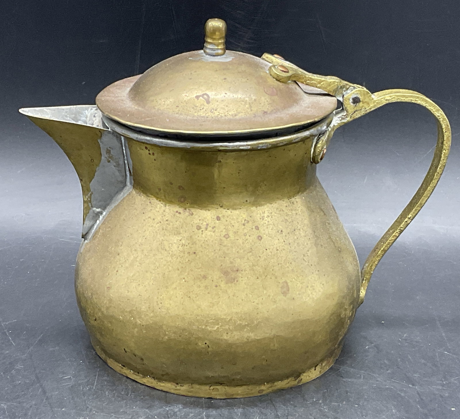 Vintage Brass Tone Metal Teapot: Vintage Brass Tone Metal Teapot. Measures approx. 7H x 6.5W in. Measurement includes handle and spout. Losses to finish, loose pieces, surface wear, and denting present. home decor, home accents, home