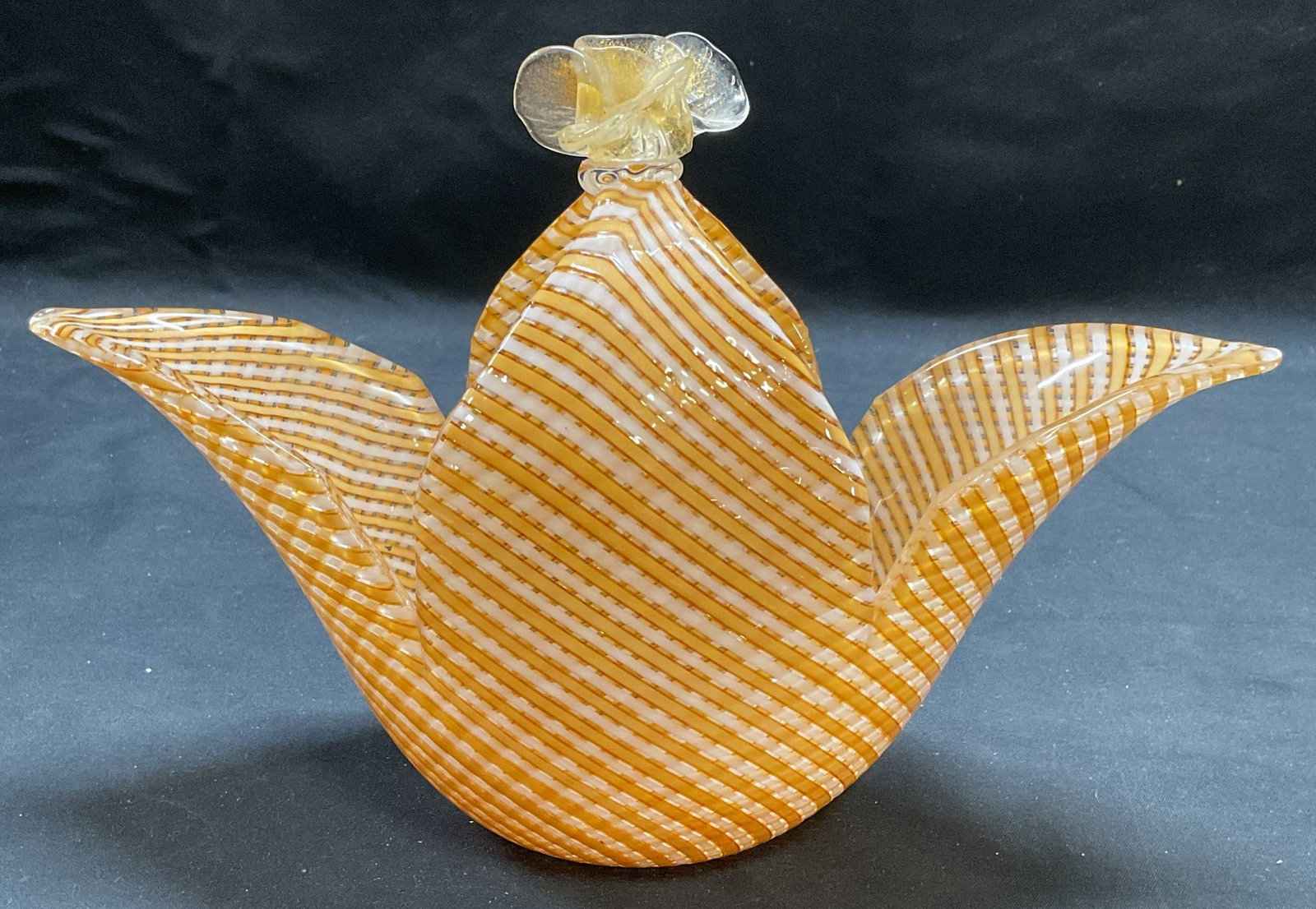 Orange & White Art Glass Flower Basket: Hand blown orange and white lattice pattern flower motif basket. Measures approx. 9.75 x 3.75 x 6.75 inches. Some surface wear including scratching observed. Hairline crack at neck. Art glass, art gla