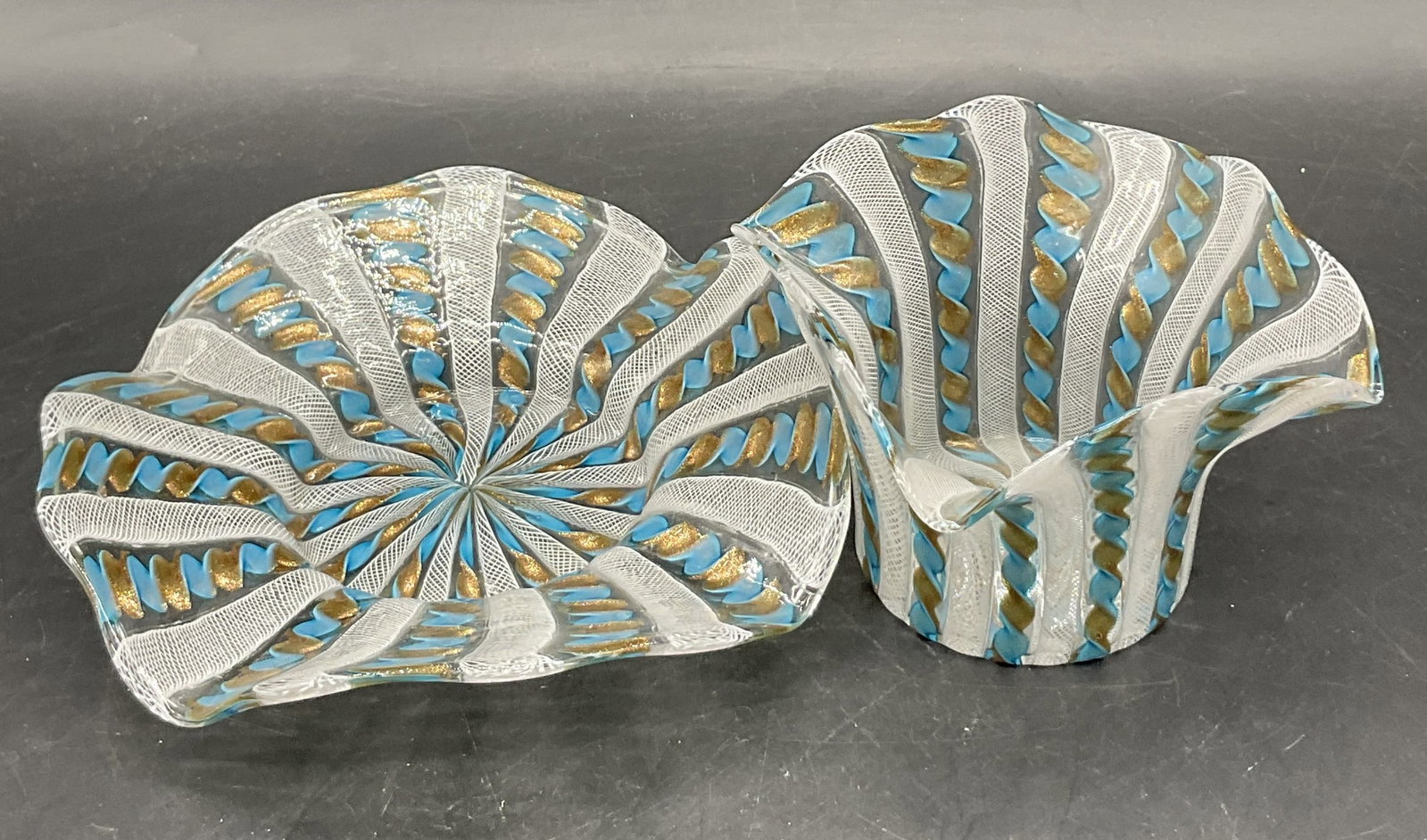 Set 2 Murano Style Art Glass Vessel & Plate: Set 2 Murano Style Art Glass Vessel & Plate. Crafted from clear, white, blue, and shimmery gold glass. Twist design alongside ruffled rims. Pontil to the undersides. Vessel measures approx. 3H x 4W in
