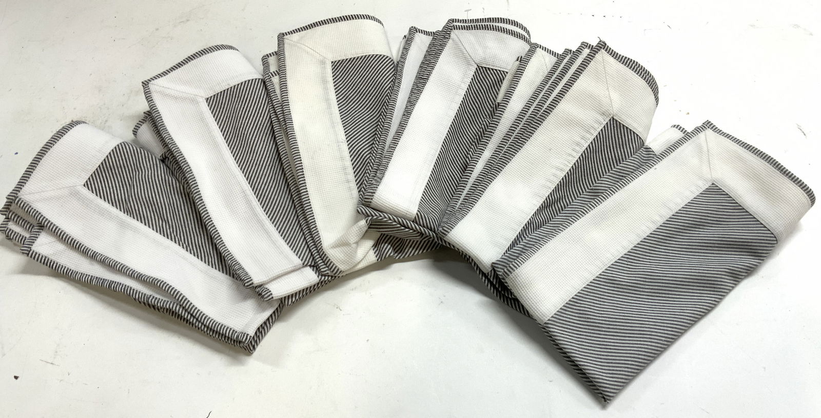 JULISKA Set 5 Striped Table Linen Napkins: Tag reads JULISKA. Lot includes 5 table linen napkins. Each have white and black toned diagonal stripe pattern detail. Each measures approximately 22 inches square. Napkins, table linens, linens, tabl