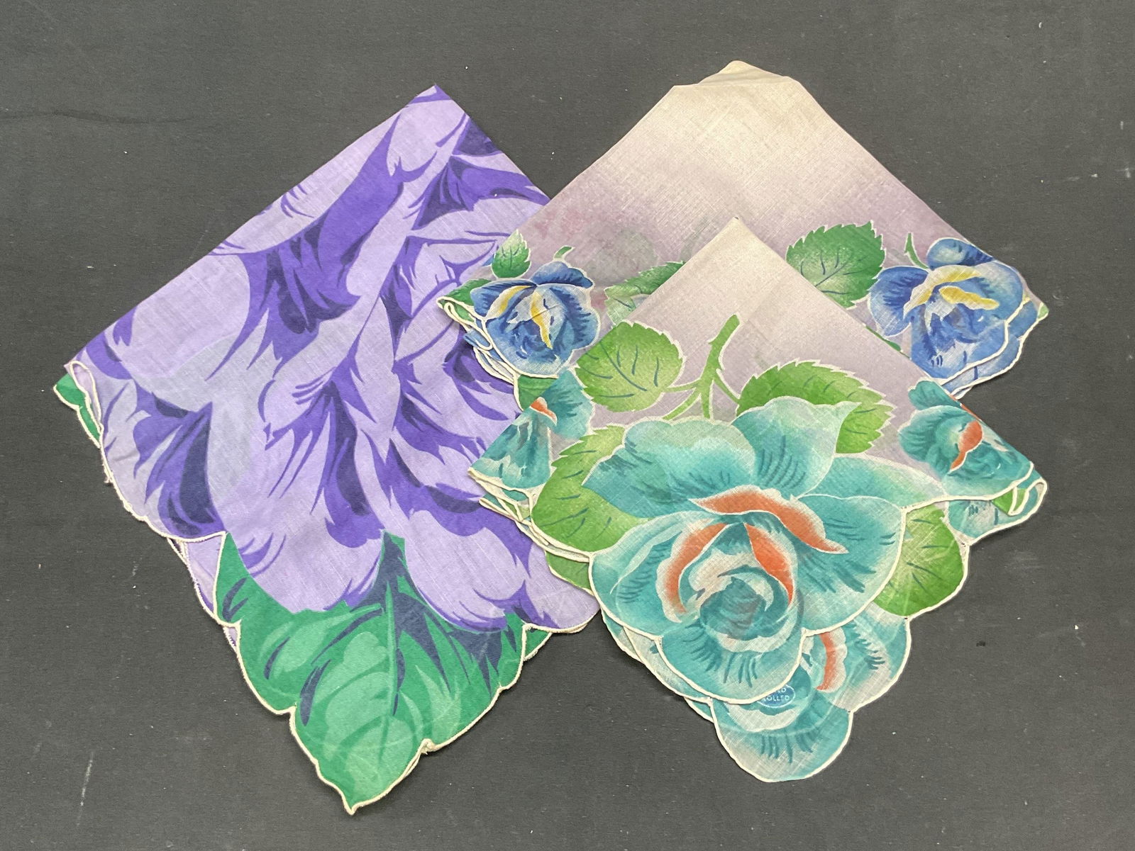 Lot 3 Vintage Green & Purple Floral Handkerchiefs: Lot of 3 vintage floral print handkerchief. Green, blue, and purple Feel like cotton. Largest approx 16 x 15 inches. All pieces have wear including blemishes observed. Handkerchief, vintage handkerchi