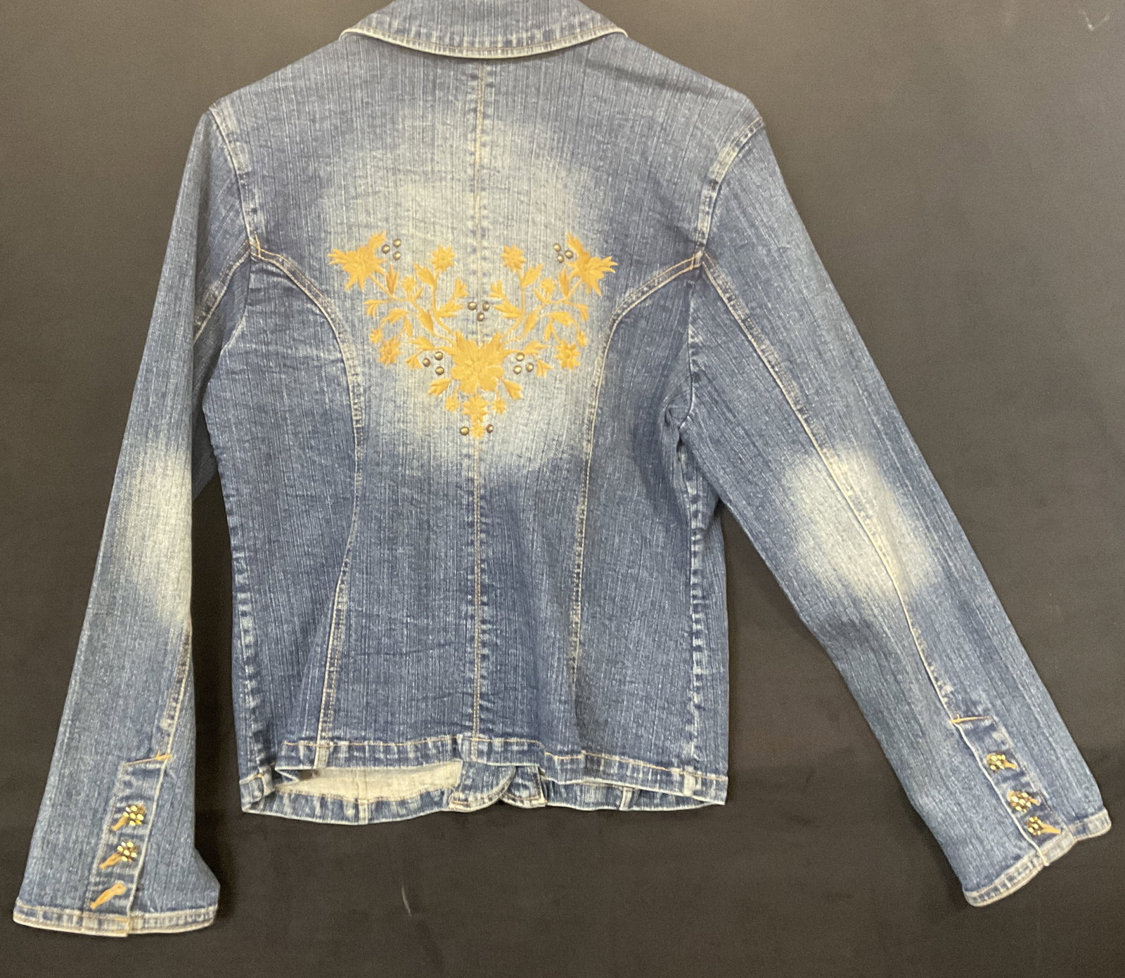 FADED GLORY Denim Floral Embroidery Jacket: FADED GLORY Denim Floral Embroidery Jacket. Bejeweled metal buttons to the obverse and floral embroidery to the reverse. Brand tag reads FADED GLORY STRETCH. Size tag reads 12 Missy. Material tag read