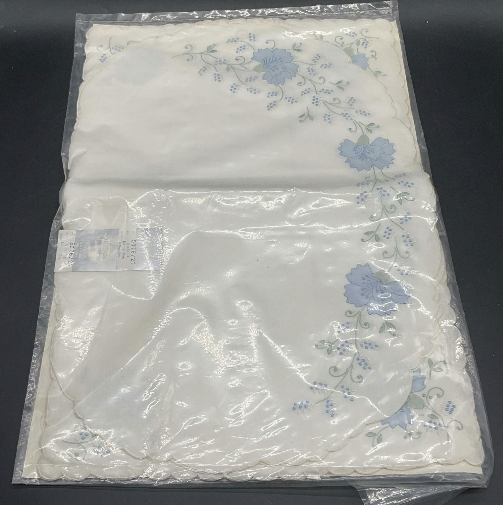IMPERIAL CORONET LINENS Floral Motif Linens: IMPERIAL CORONET LINENS Floral Motif Linen Napkins / Placemats. Blue florals throughout. Measures approx. 13.5L x 19.5W in. Not examined out of packaging. Surface wear consistent with age, use, and ex