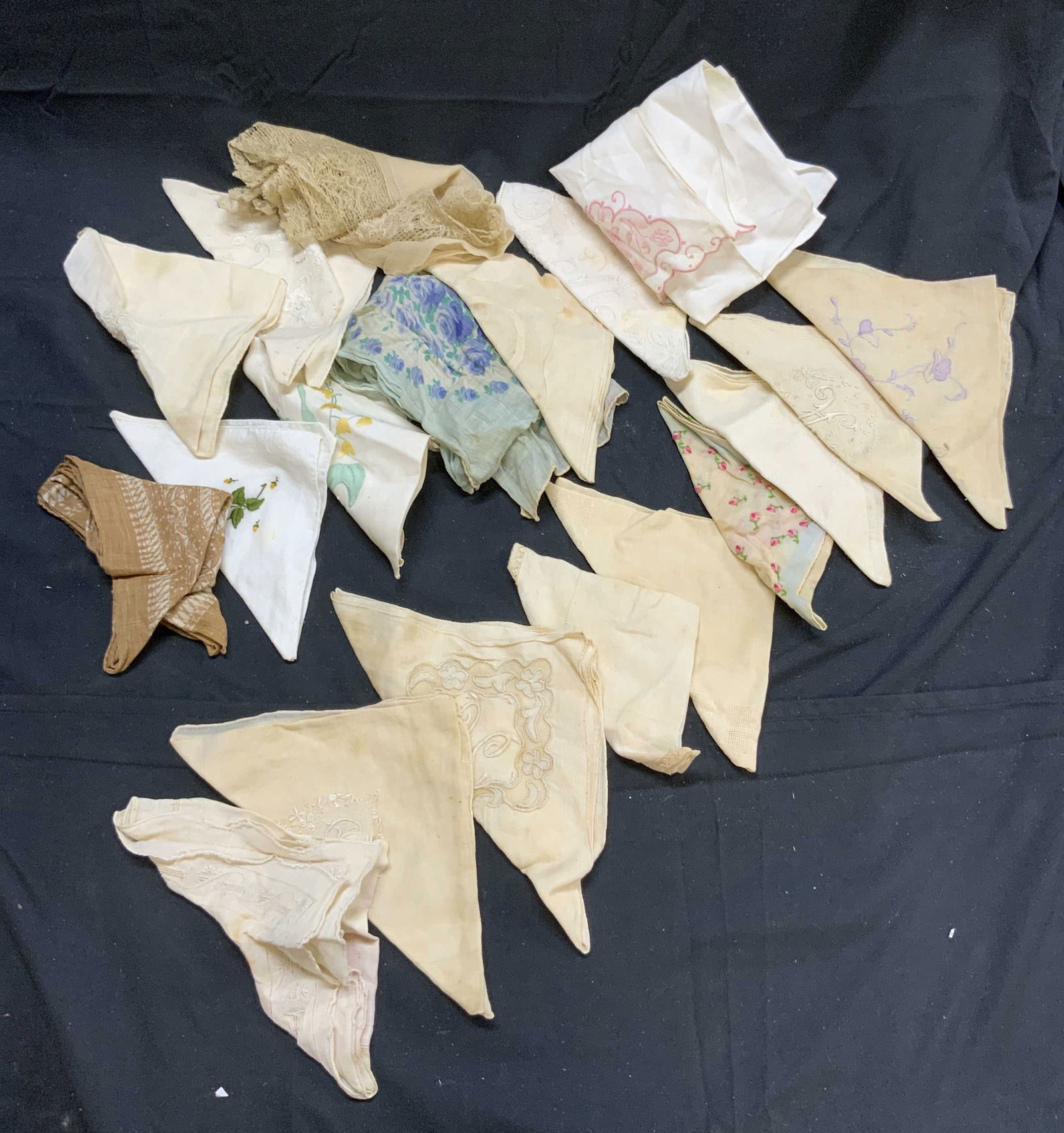 Lot 19 Vtg Assorted Table Linens & Handkerchiefs: Lot include 19 linens. Including tan, & white tones. Some have embroidered floral and leaf detail. Others have multi toned floral and leaf detailing. One has doily edge. Largest piece measures approxi