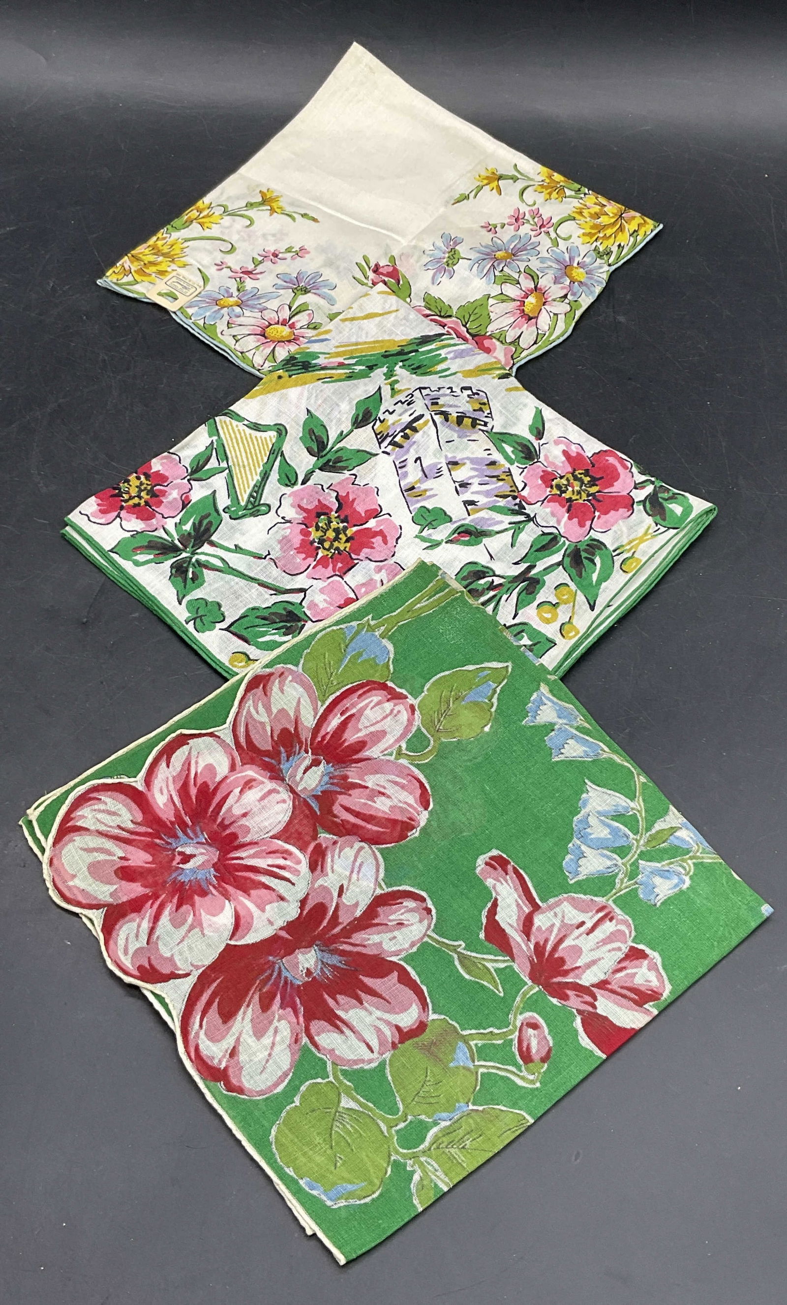 3 Vintage Multicolored Floral Motif Handkerchiefs: Three Vintage Multicolored Floral Motif Handkerchiefs. Crafted from soft hand fabric. HANDKERCHIEF OF THE MONTH AS SEEN IN VOGUE Hankie Measures approx. 14W x 13L in. Pieces have some surface wear and