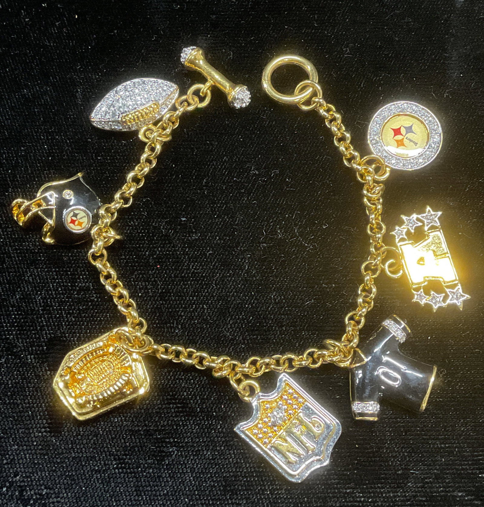 Gold Tone NFL Football Crystal Charm Bracelet: Gold tone charm bracelet. NFL football themed charms. Measures approx 7 inches long. Some wear including scratching observed. Jewelry, estate jewelry, costume jewelry, cocktail jewelry, fashion jewelr
