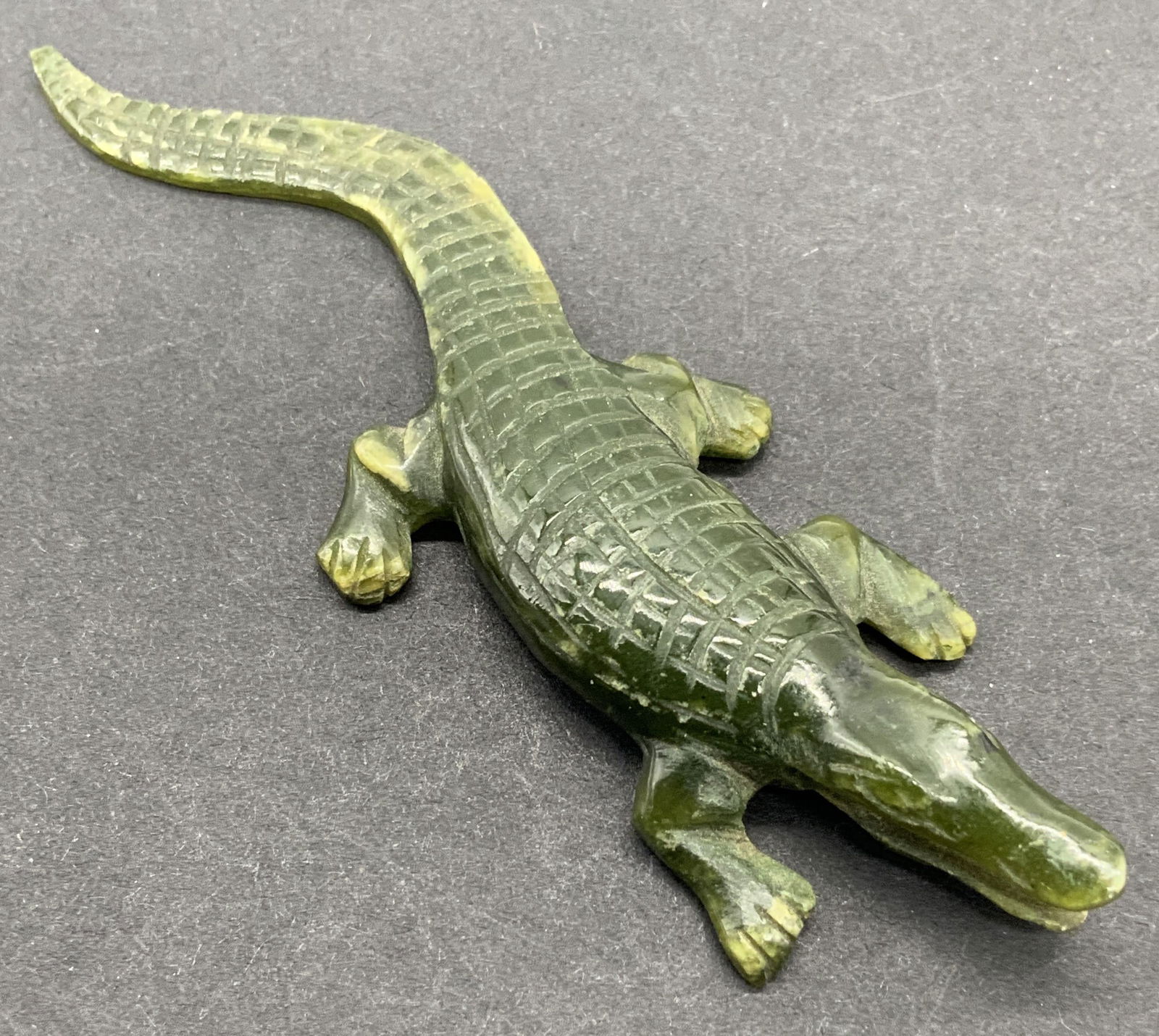 Jade Alligator Figural 3 1/2 in L: Jade stone carving, alligator / crocodile figural. Etched details of scales, eyes, toes, mouth open. Some wear throughout including scratches. Measures approx 3 1/2 in L by 1 in wide. Jade, stone scul