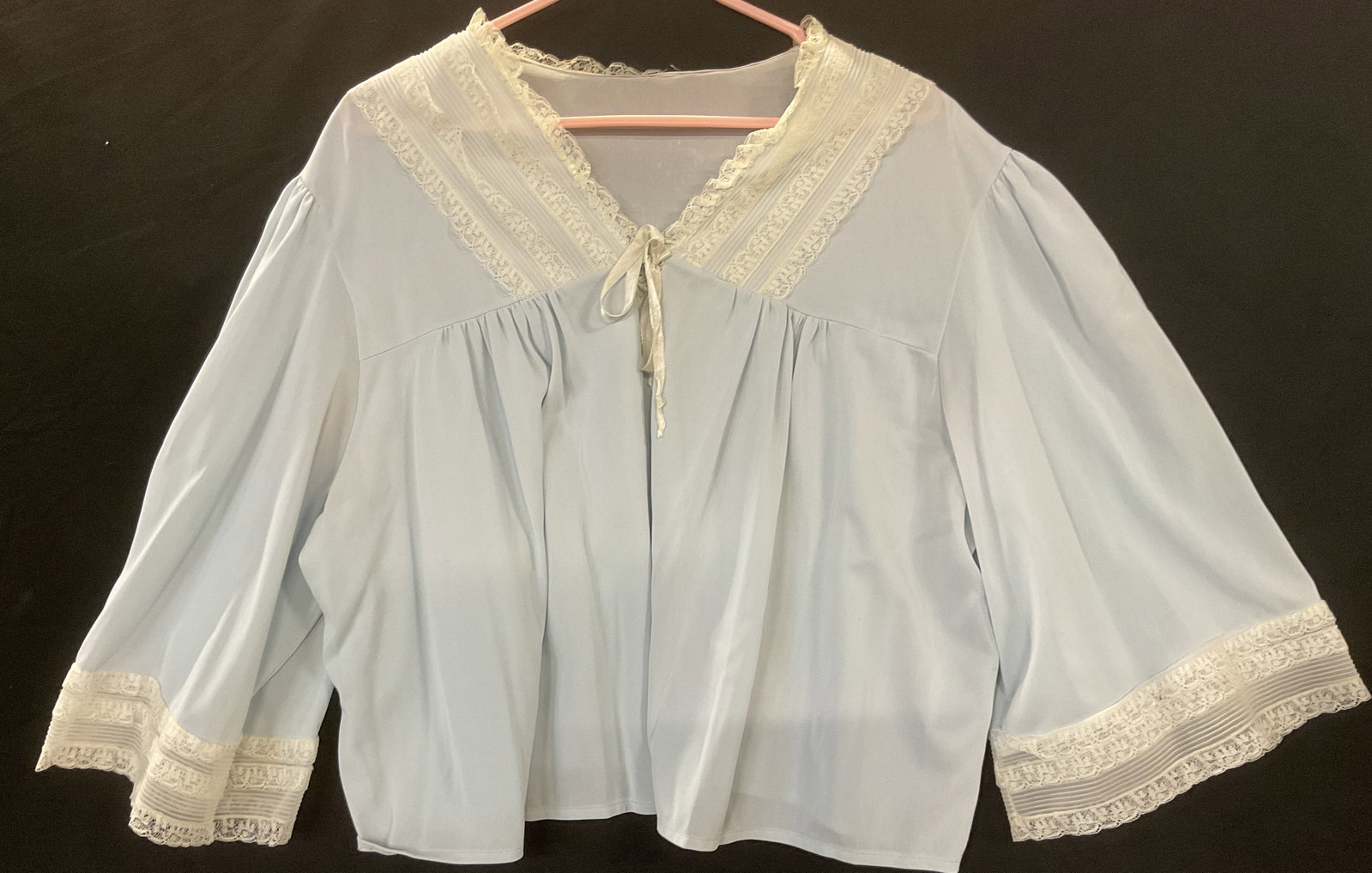 Vintage Semi Sheer Blue Lace Trim Sleep Top: Vintage semi sheer light blue and white lace trim sleep top. Measures approx 19 inches across chest. Synthetic material. Some wear including pulls and areas of discoloration. Sleep top, blue sleep top