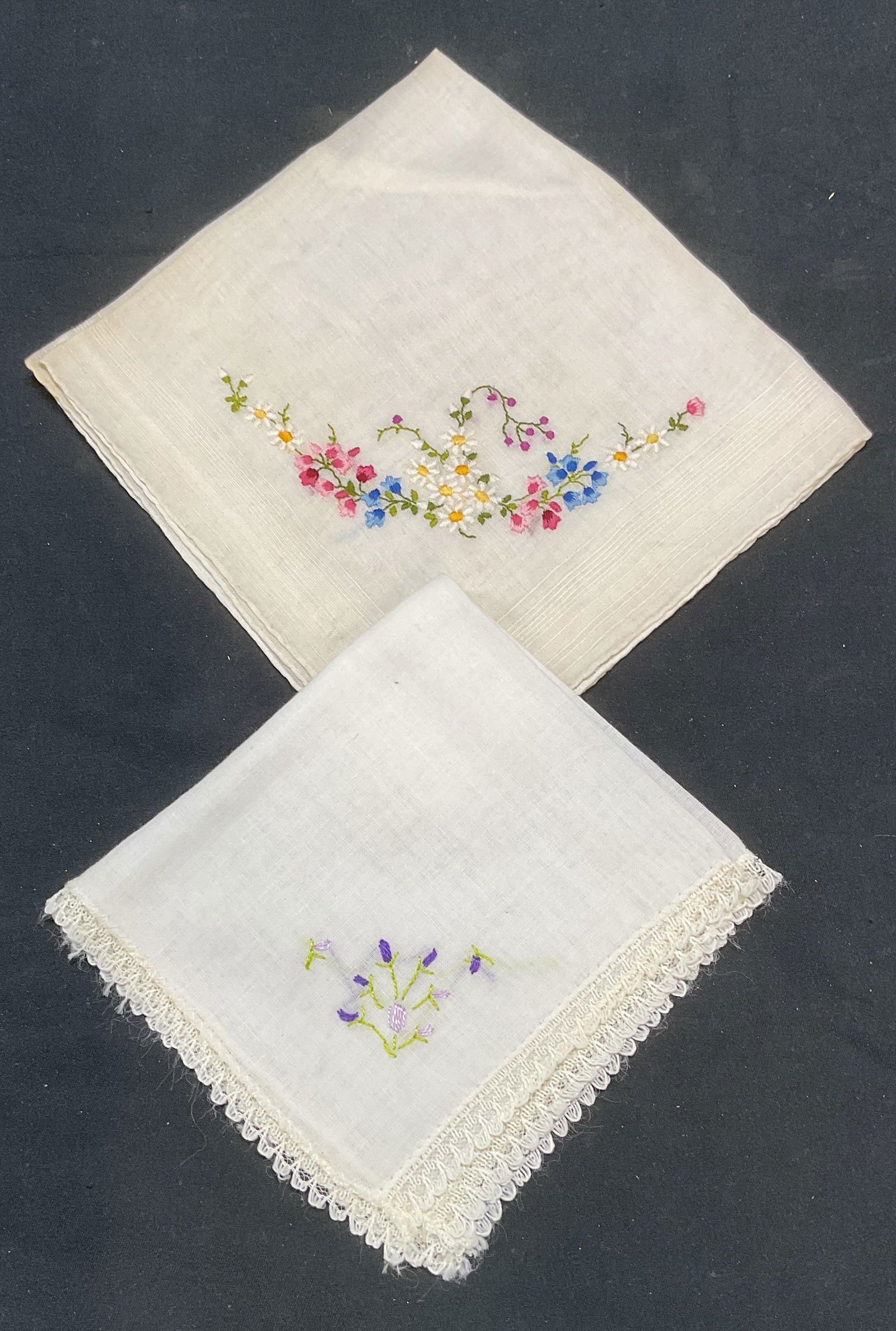 Lot 2 Vintage Floral Embroidered Handkerchiefs: Lot of 2 vintage white cotton handkerchief with floral embroidery. Larger measure approx 12 x 12 inches. Some wear to each including blemishes observed. White handkerchief, handkerchief, vintage handk