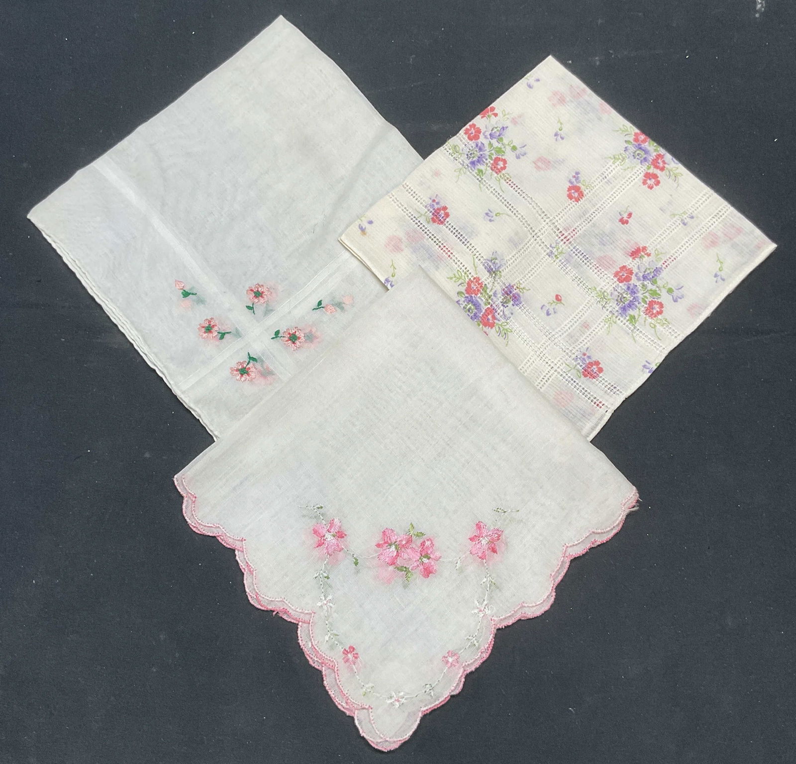 Lot 3 Vintage White Pink Floral Handkerchiefs: Lot of 3 vintage white cotton handkerchief with purple and pink embroidered and printed floral patterns. Largest approx 12 x 12 inches. All pieces have some wear including blemishes observed. Handkerc