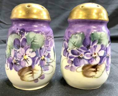 Set 2 Floral & Gilt Porc Salt & Pepper Shakers: Lot includes 2 salt and pepper shakers. Each are porcelain. Shakers each have multi toned floral and leaf detail. Tops of each piece have gilt areas. Shakers each measure approximately 3.25