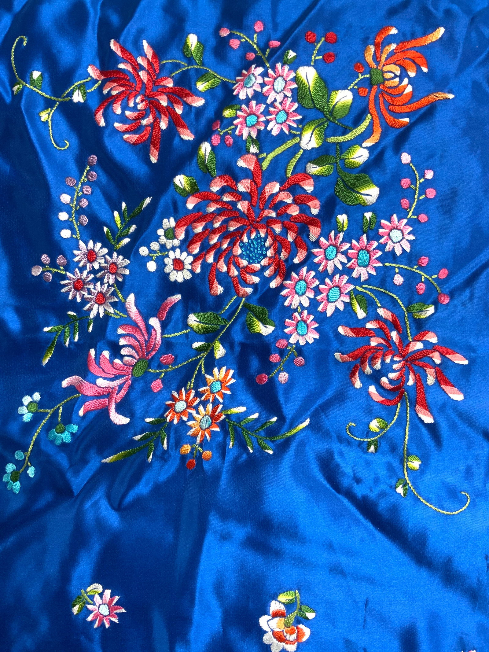 Vintage Floral Asian Satin Scarf: Scarf is blue with embroidered multi toned floral and leaf detail. Scarf appears to be satin. Scarf appears to be vintage. Piece measures approximately 27 inches square. Scarf, satin scarf, floral sca