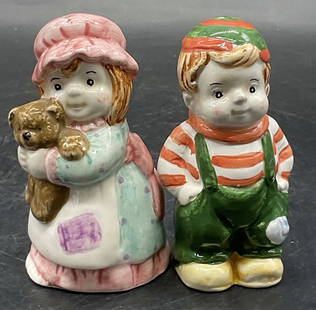 Set Signed Ceramic Figural Salt & Pepper Shakers: A set of vintage ceramic salt and pepper shakers. Two pieces. One figural depicts a girl holding a teddy bear and the other depicts a boy with his hands in his pockets. Undersides are signed,