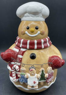 AGC INC. GINGERBREAD LANE Ceramic Cookie Jar: AGC INC. GINGERBREAD LANE Ceramic Cookie Jar. Subject is a jolly gingerbread man holding up a row of gingerbread children & holiday motif cookies. Measures approx. 11.5H x 8W in. Sticker to
