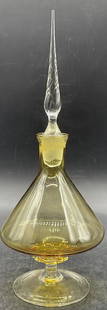 Vintage Amber & Clear Art Glass Perfume Bottle: Vintage Amber & Clear Art Glass Perfume Bottle. Comes with stopper. Measures approx. 10.5H x 3.5W in. Bubbles to glass. Surface wear consistent with age, use, and exposure. Chipping to stopper.