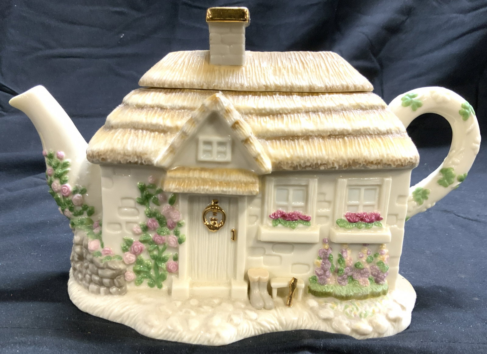 LENOX The Irish Blessing Porcelain Teapot W Lid: Underside reads LENOX THE IRISH BLESSING TEAPOT. Teapot is porcelain. Piece has cottage form. Teapot includes lid. Lid has chimney form with gilt rim. Piece measures approximately 9.5 inches deep 5.5 